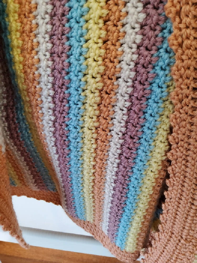Multi coloured crochet baby blanket.