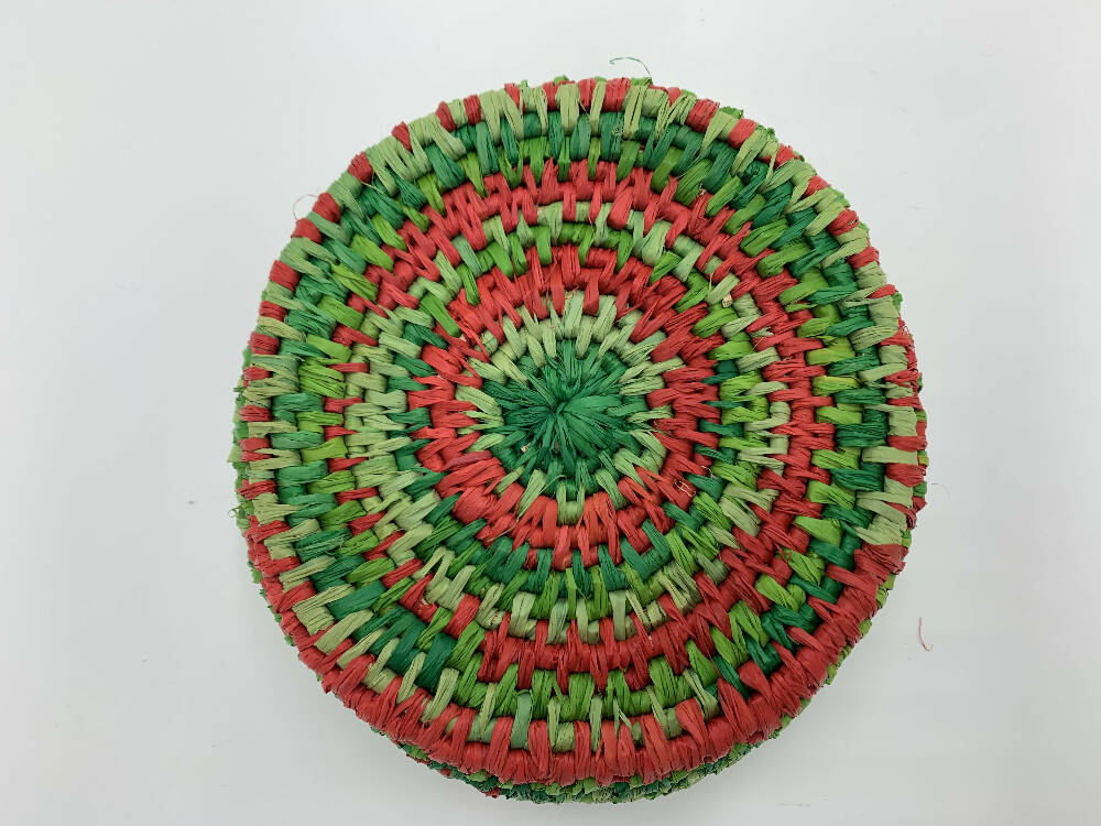 Basket in shades of green and red raffia