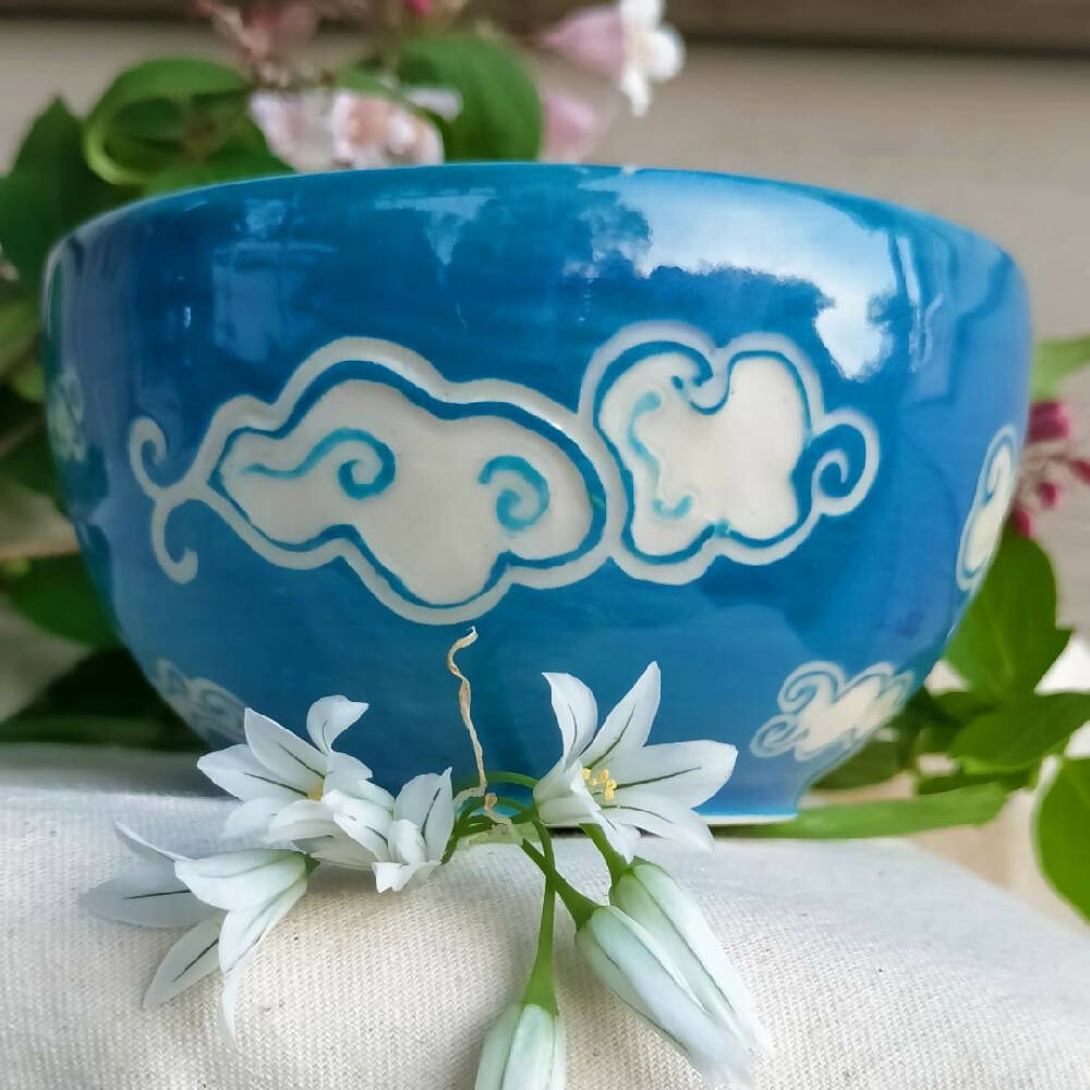 Blue sky, white clouds. Small hand made condement bowl