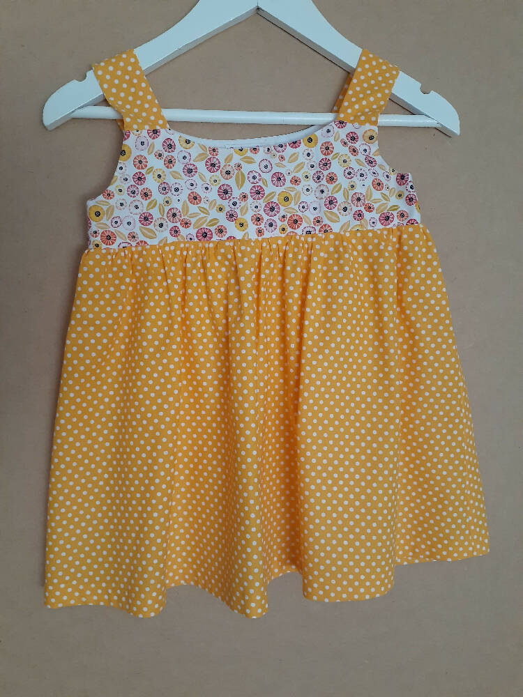 Cute size 2 child's dresses. One-Of-A-Kind Print Bodice with Contrasting Spots. Available in 2 colours.