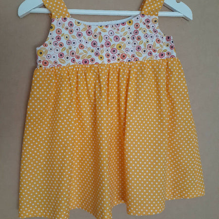 Cute size 2 child's dresses. One-Of-A-Kind Print Bodice with Contrasting Spots. Available in 2 colours.