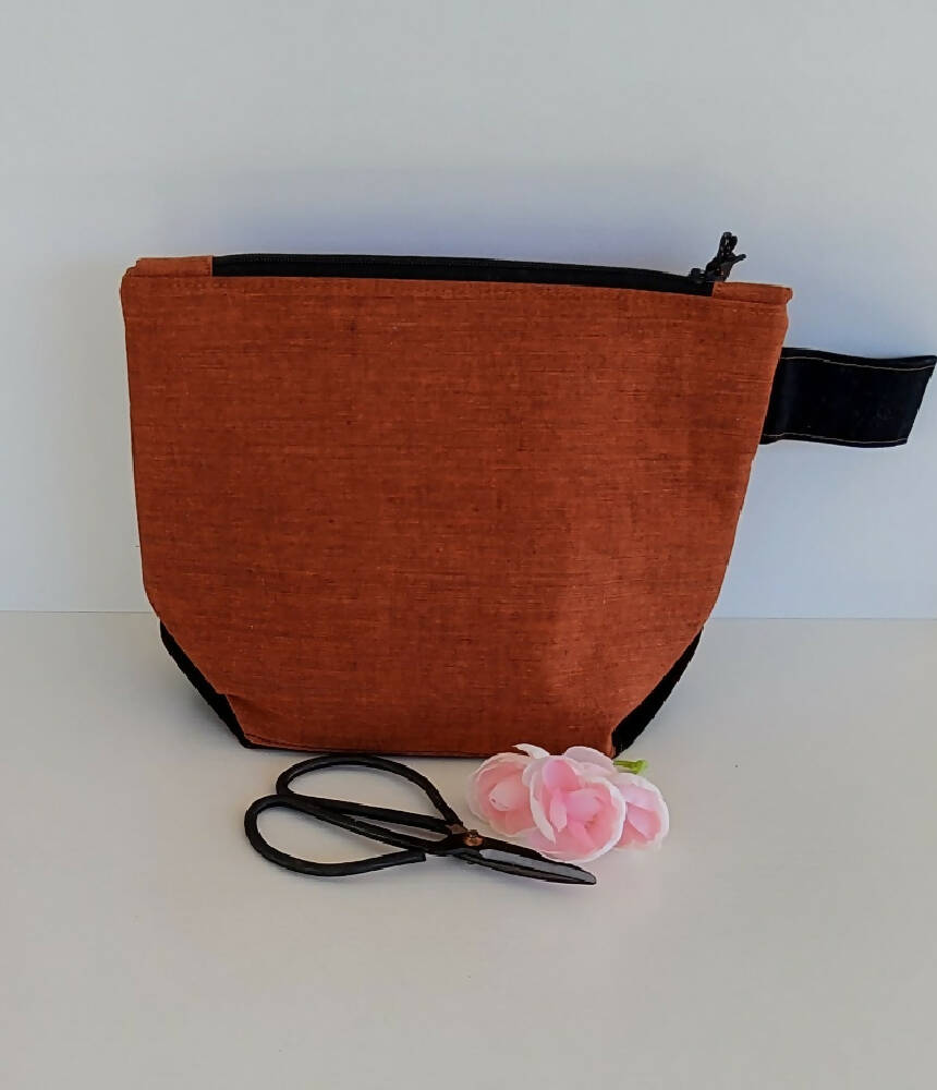 Rusty/orange zippered bag/ pouch.