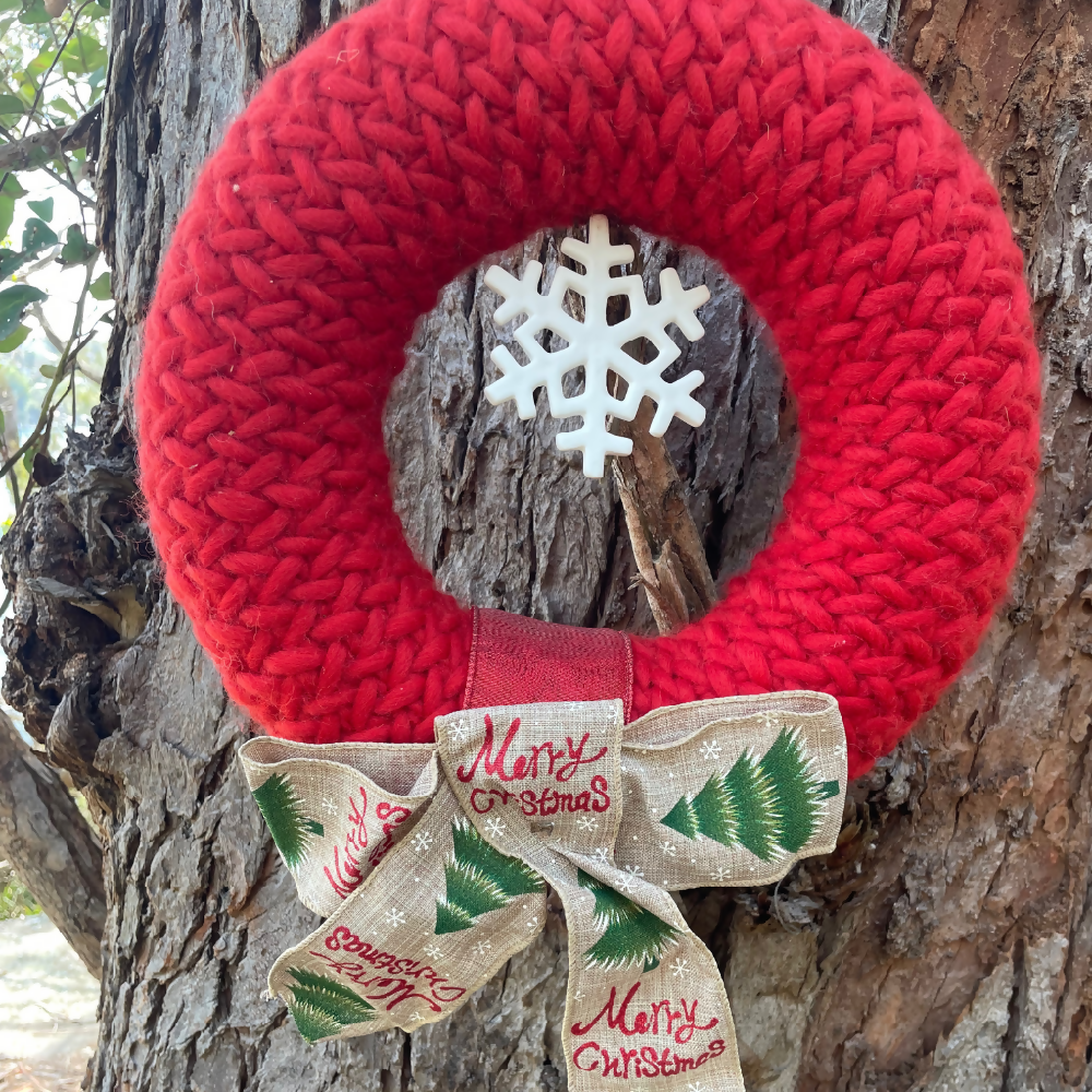 Handknitted Christmas Wreath. Glorious red with ceramic snowflake