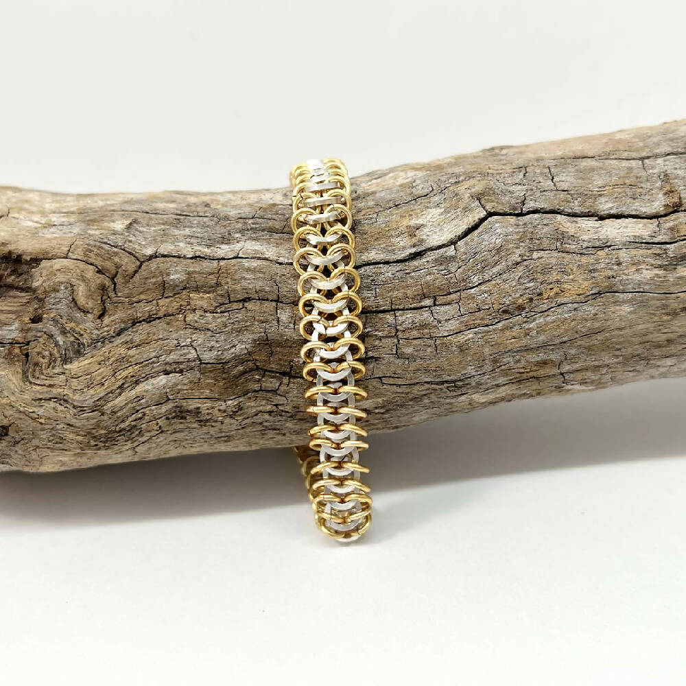 Sterlilng silver centipede & gold bracelet on log