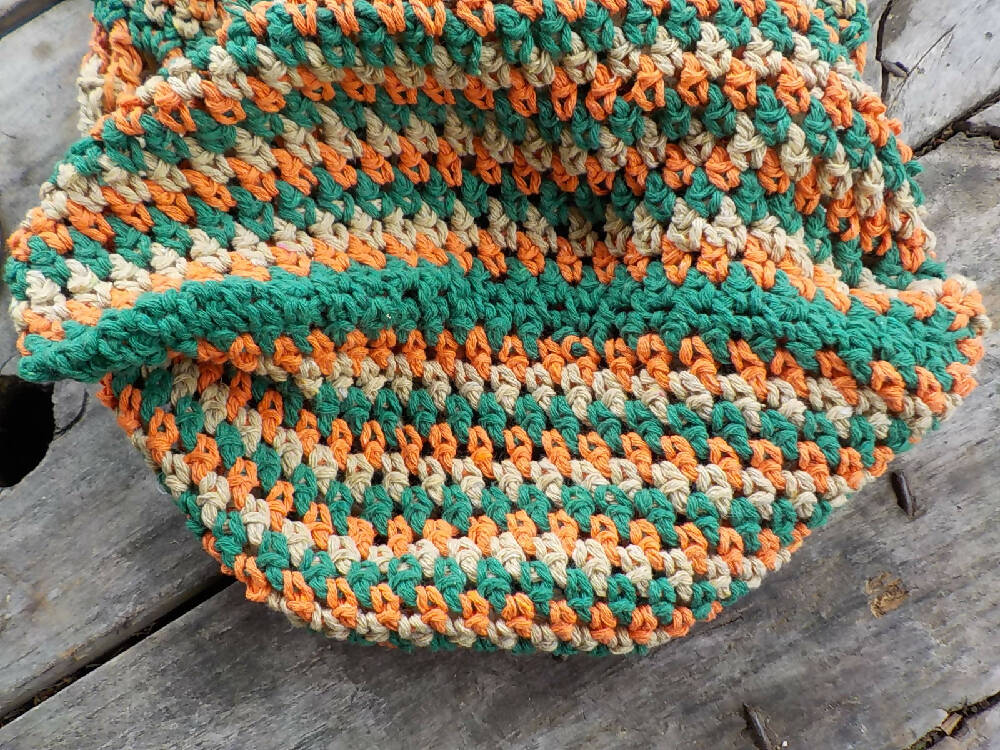 crocheted shopping carry string bag made from green, orange and beige cotton