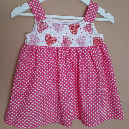 Cute size 1 child's dresses. One-Of-A-Kind Print Bodice with Contrasting Spots. Available in 2 colours.