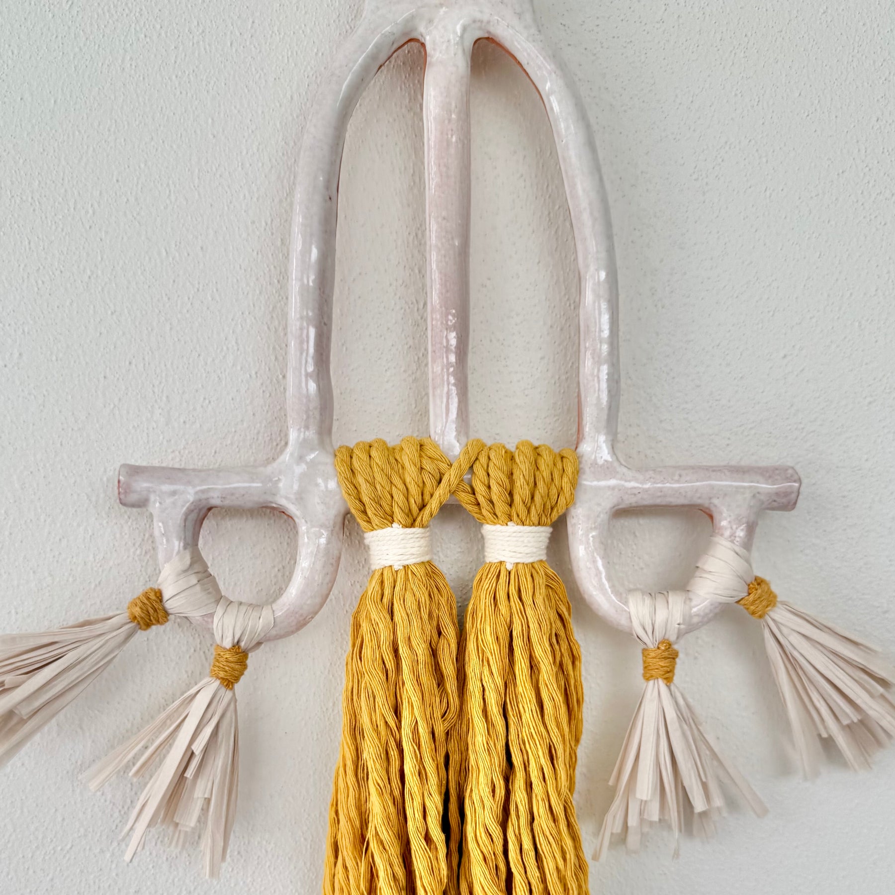 Clay and cord wall hanging