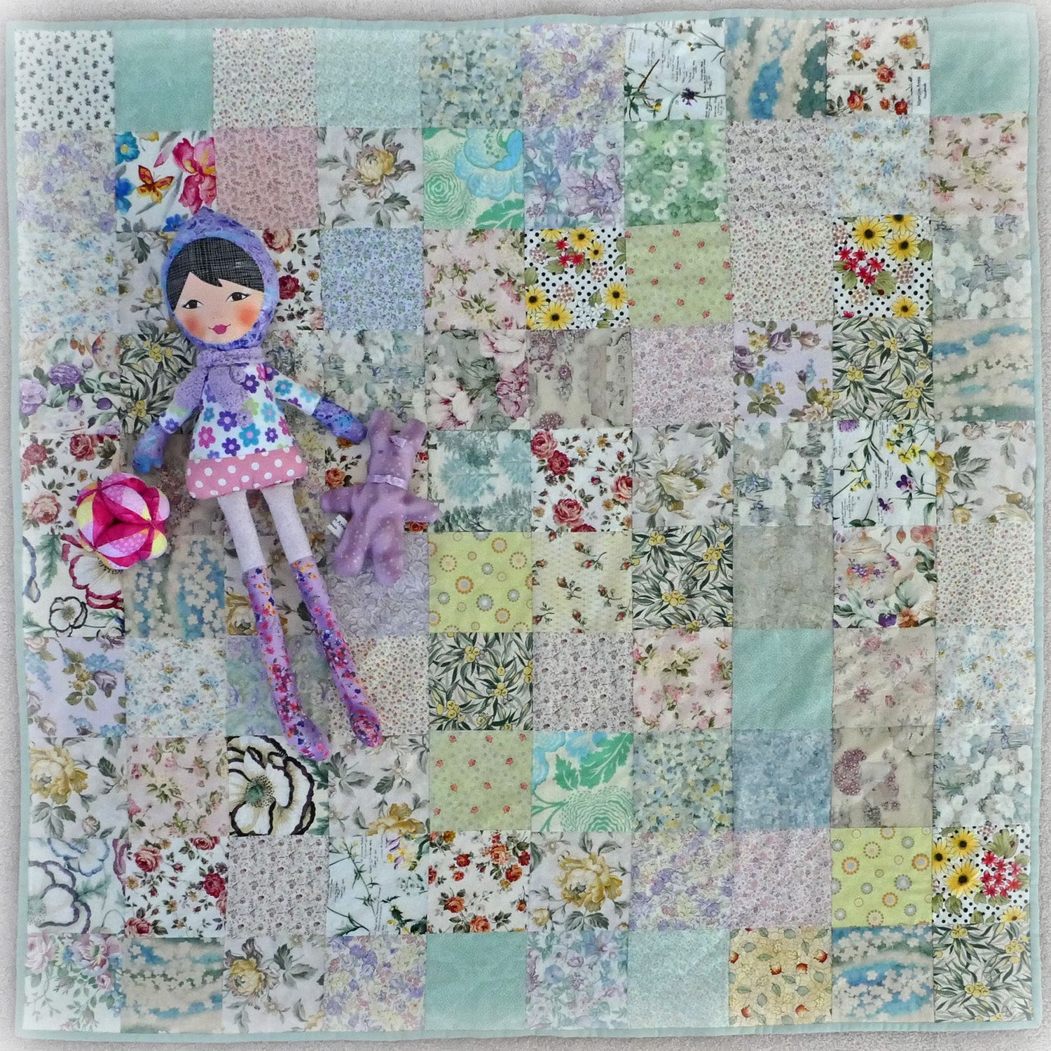 Handmade knee rug with chenille backing. Pretty florals