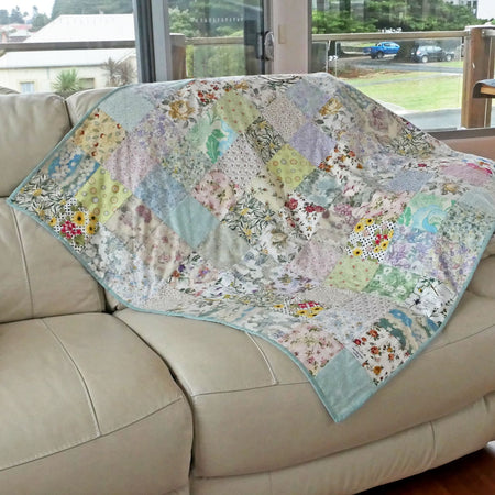 Handmade knee rug with chenille backing. Pretty florals