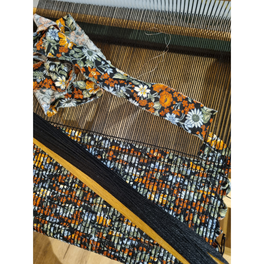 Woven black and orange floral tablerunner