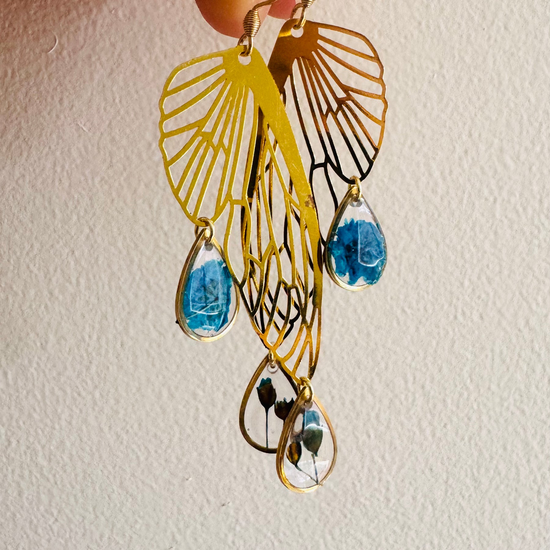 Butterfly resin earring with blue pressed flowers