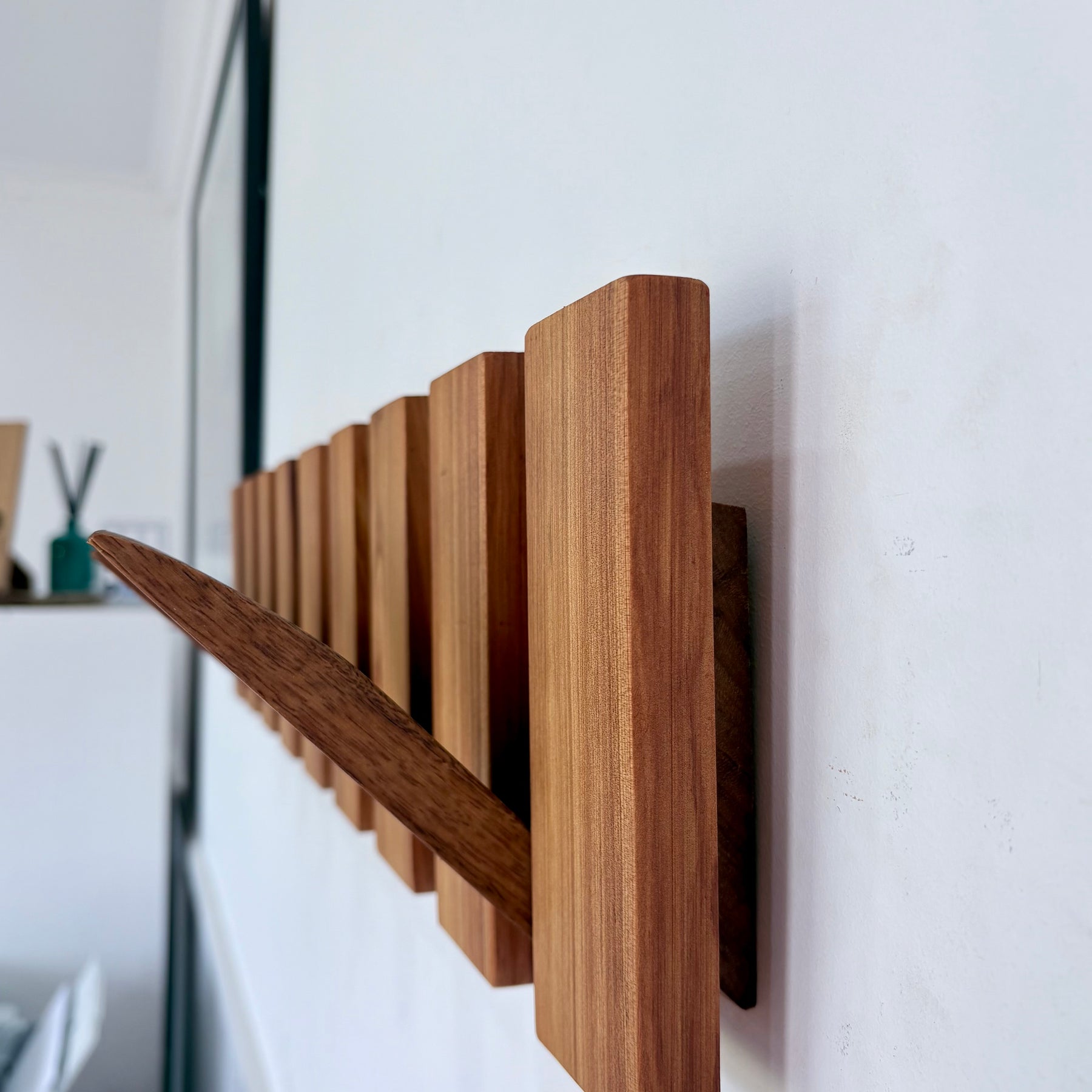 Two tone spotted gum and cypress horizon line piano style coatrack