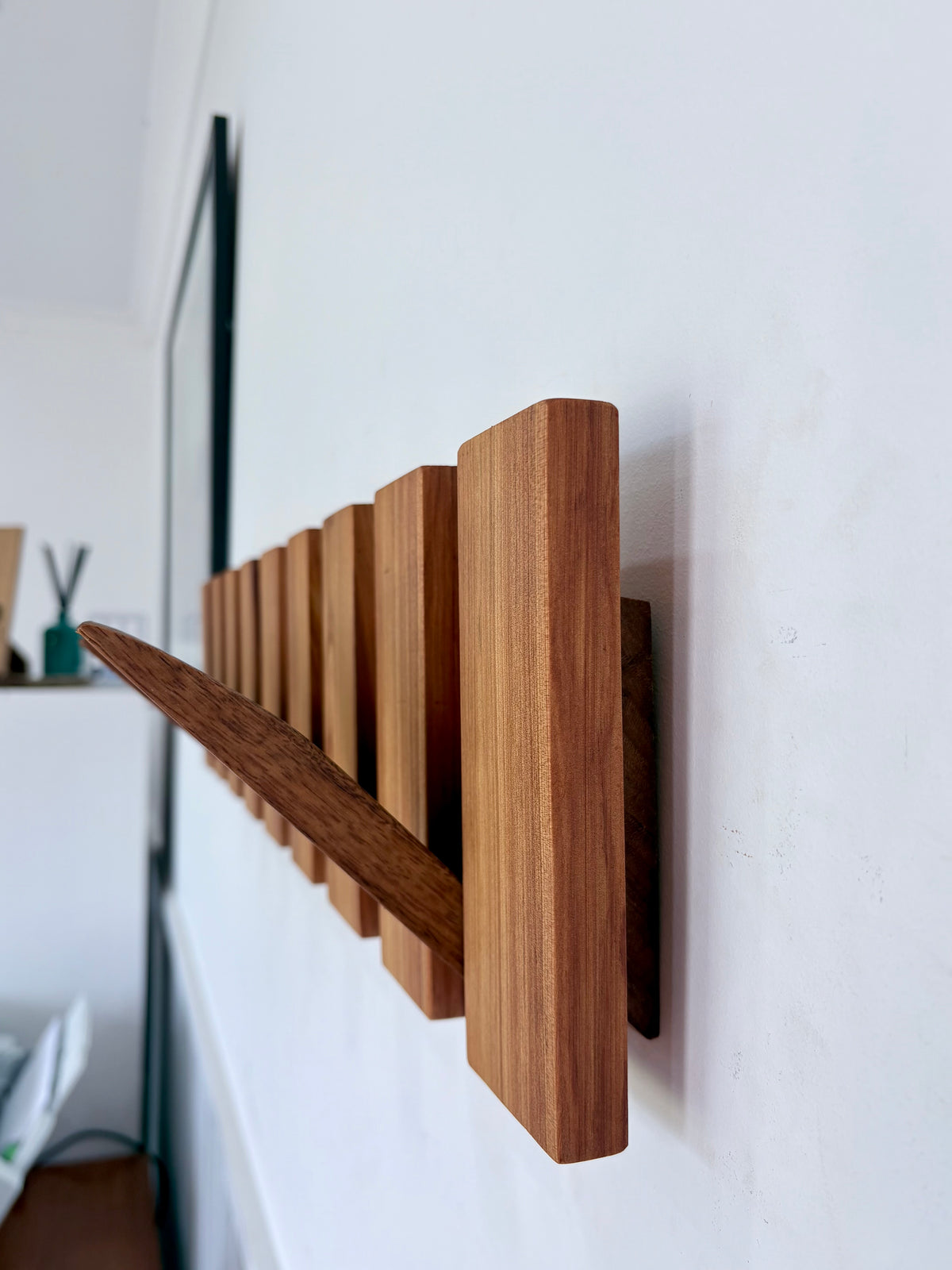 Two tone spotted gum and cypress horizon line piano style coatrack
