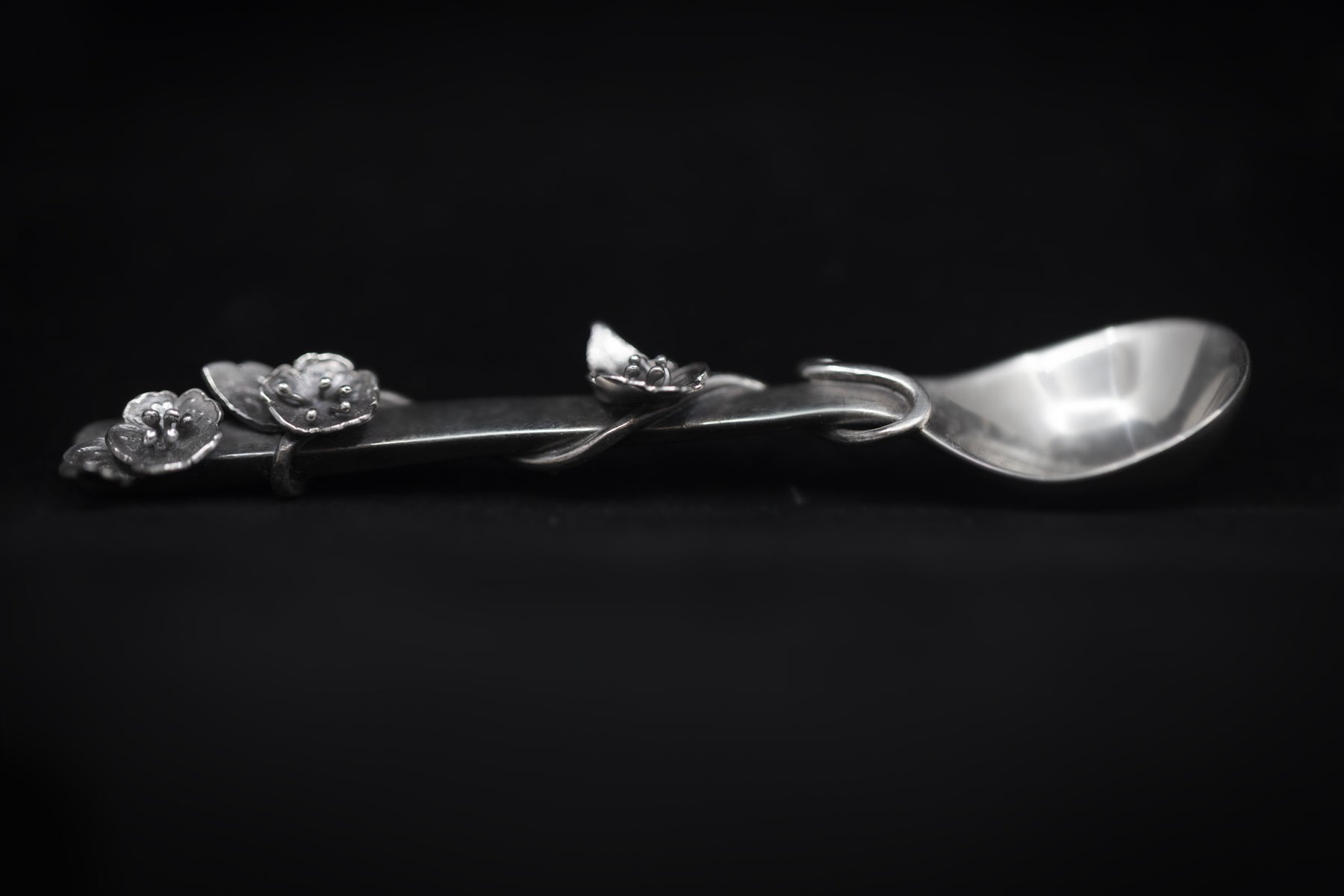 Sterling silver salt spoon with flowers