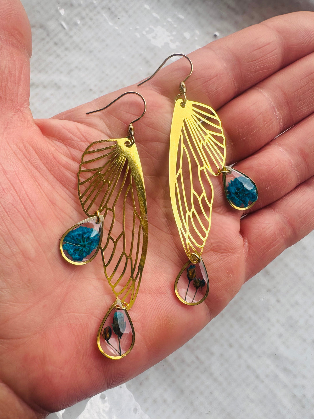 Butterfly resin earring with blue pressed flowers