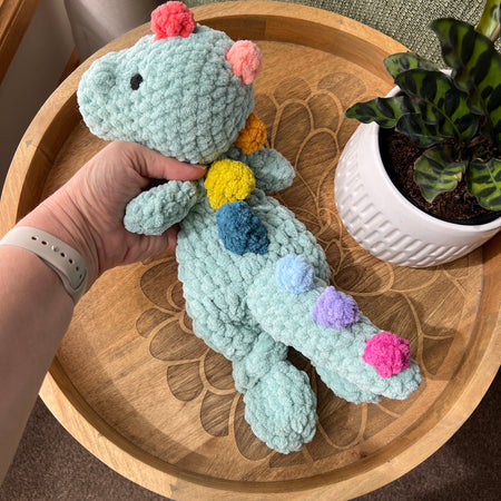 (Copy) Handmade crochet Dinosaur modern lovey snuggler with knotted legs and rainbow spikes.