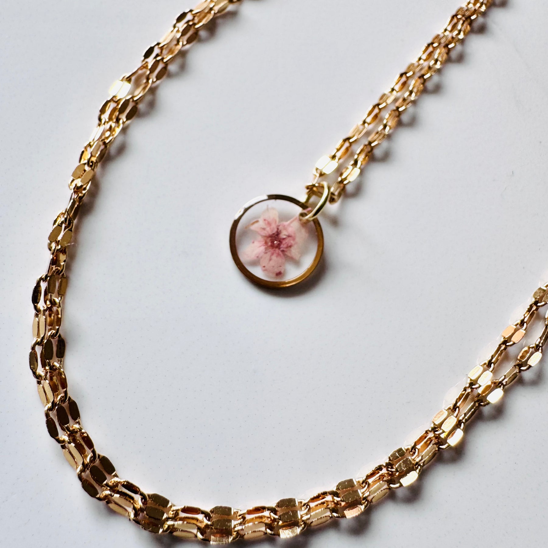 Gold plated resin necklace with pink wildflower