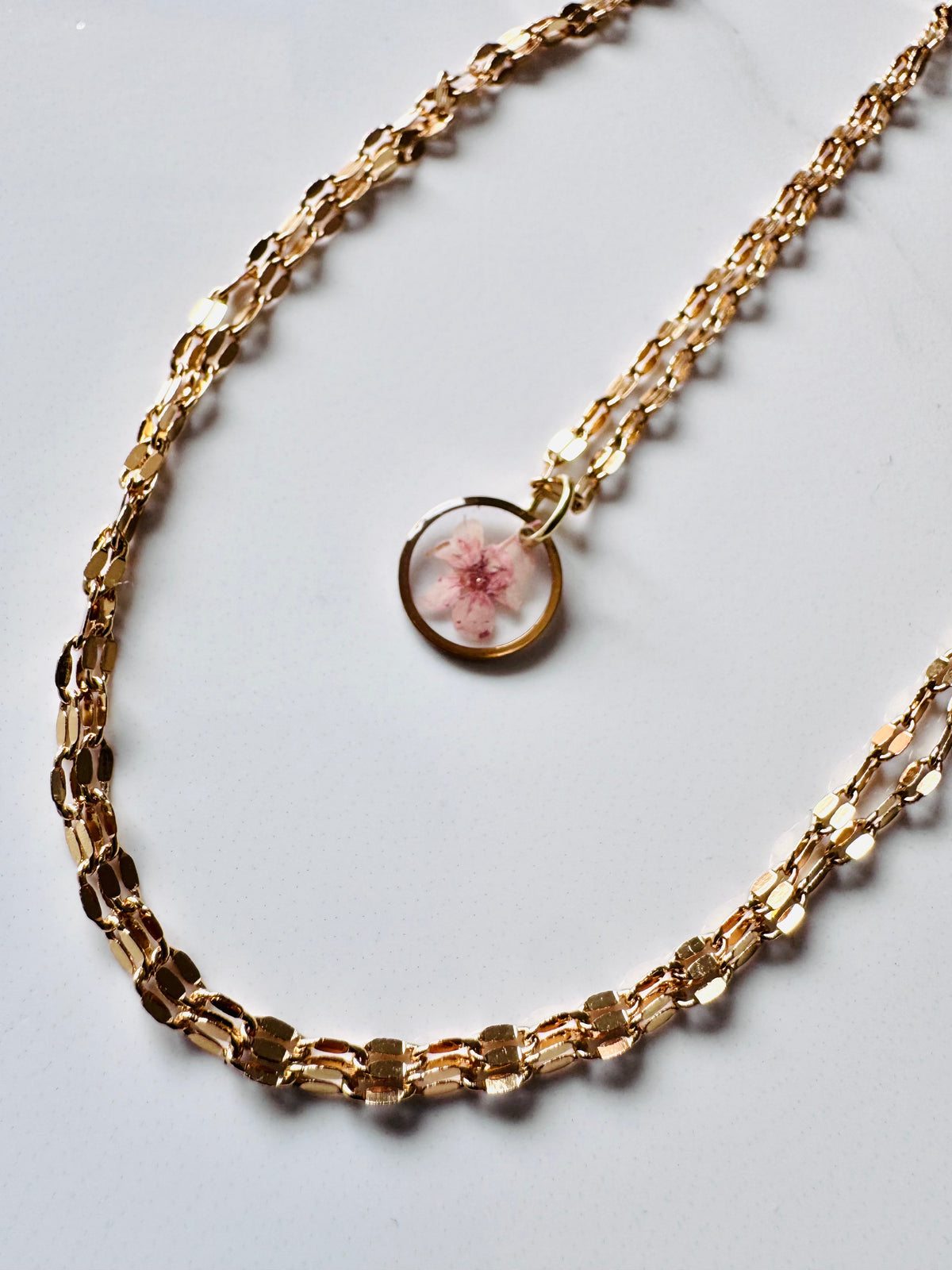 Gold plated resin necklace with pink wildflower