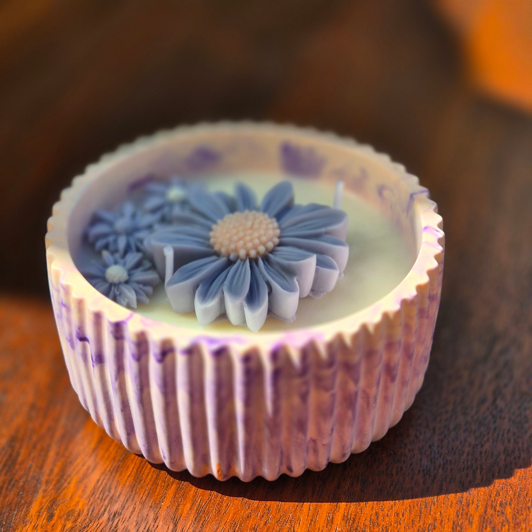 Round orange and purple concrete bowl candle with rose and lavender scent
