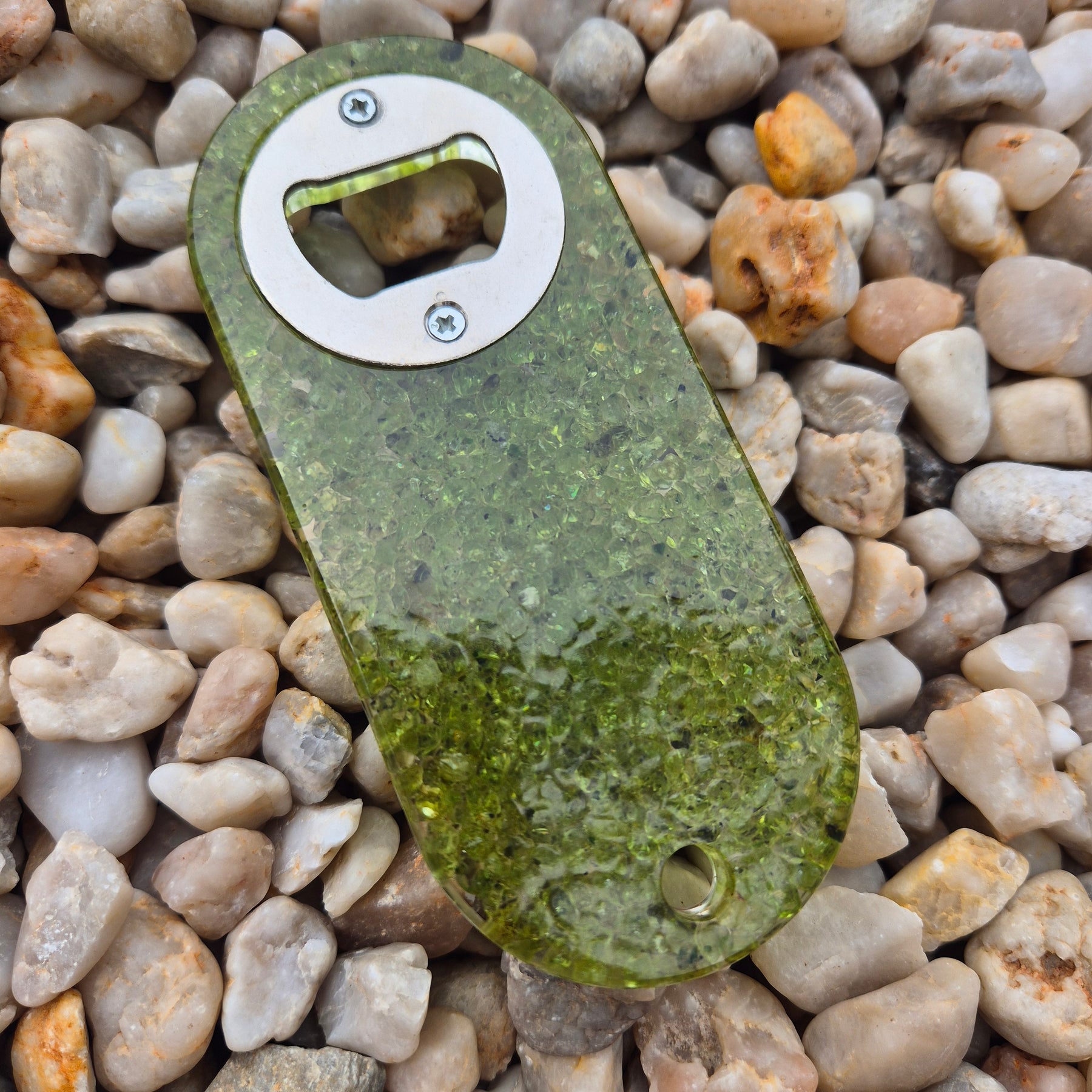 Resin bottle opener with inlaid peridot stones
