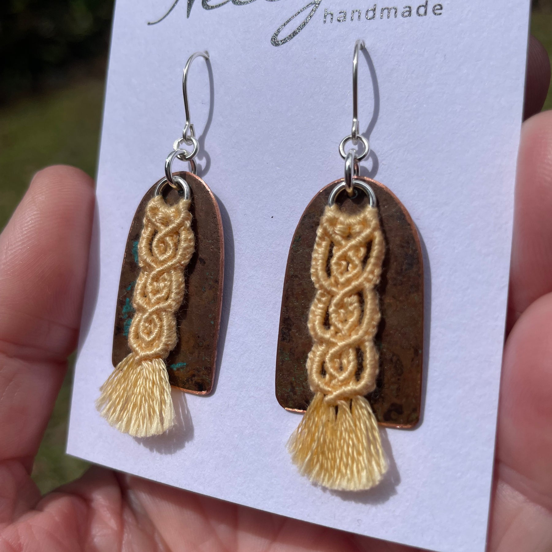 Yellow macrame thread on patinated copper