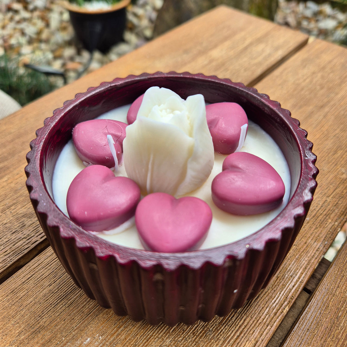 Round burgundy concrete bowl candle with tulip flower