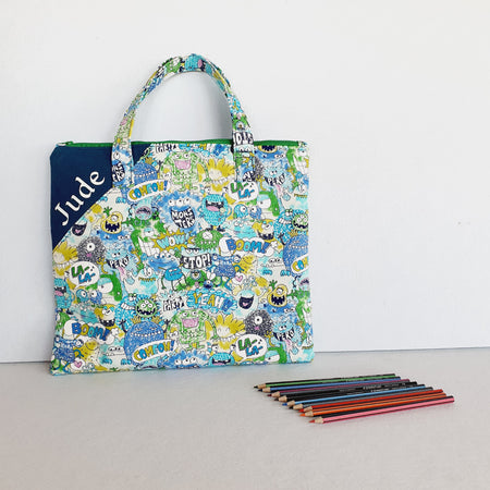 Personalized friendly monsters inspired library and laptop bag with glow-in-the-dark name