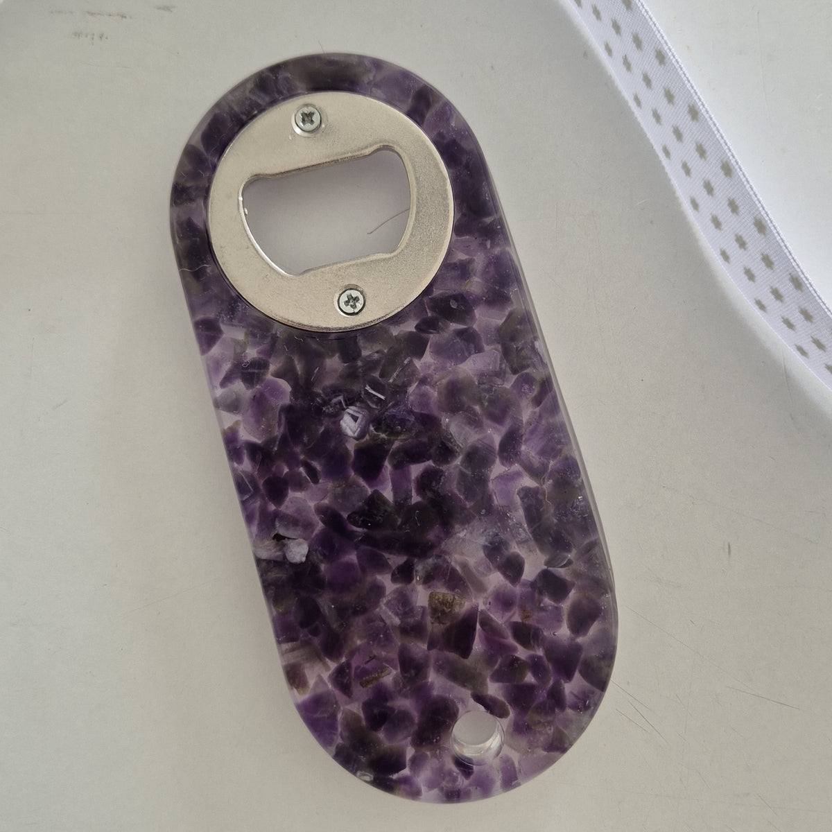 Resin bottle opener with inlaid semi-precious amethyst stones