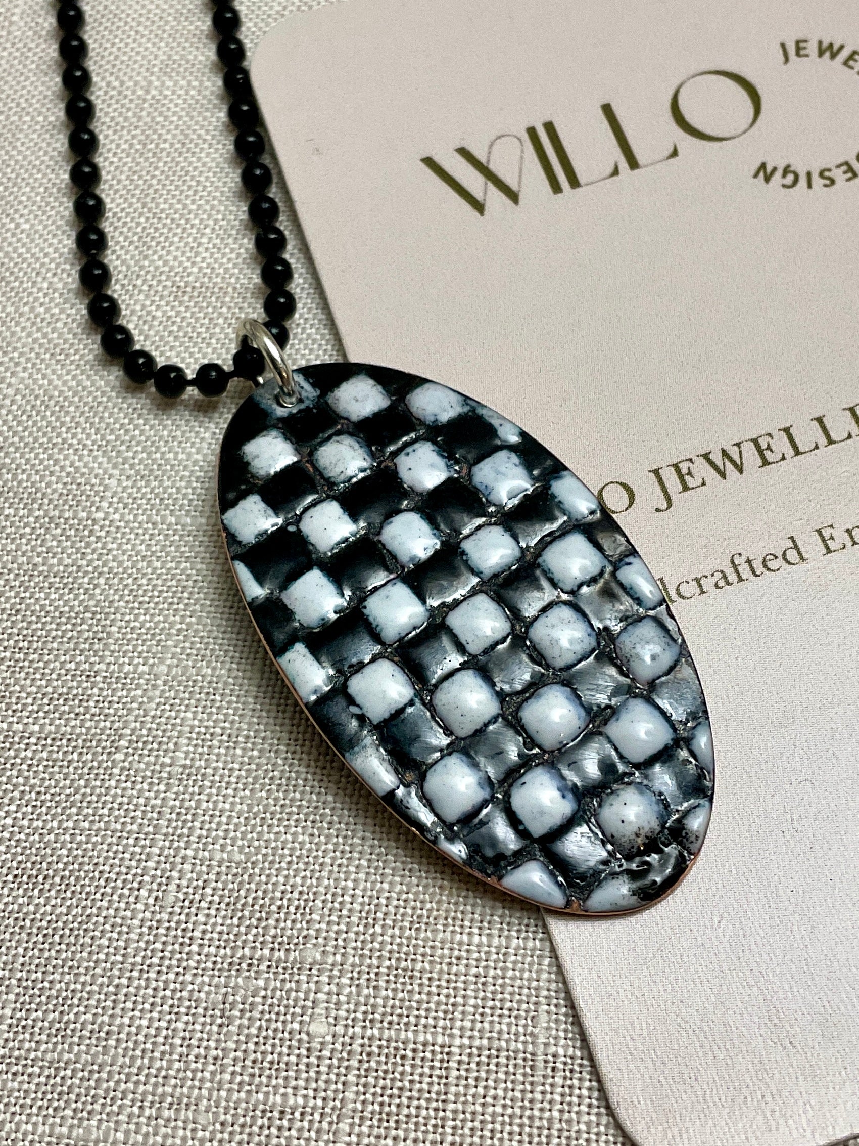 Black and white patchwork enamel pendant. Copper and enamel