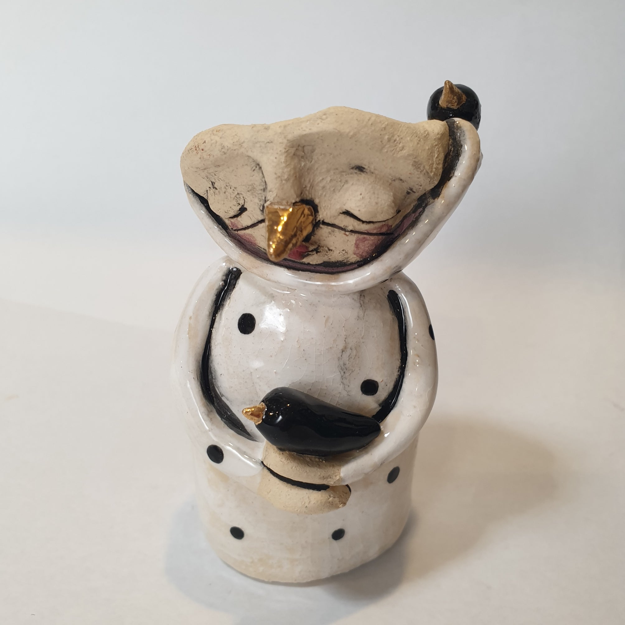little clay character, birds and dots