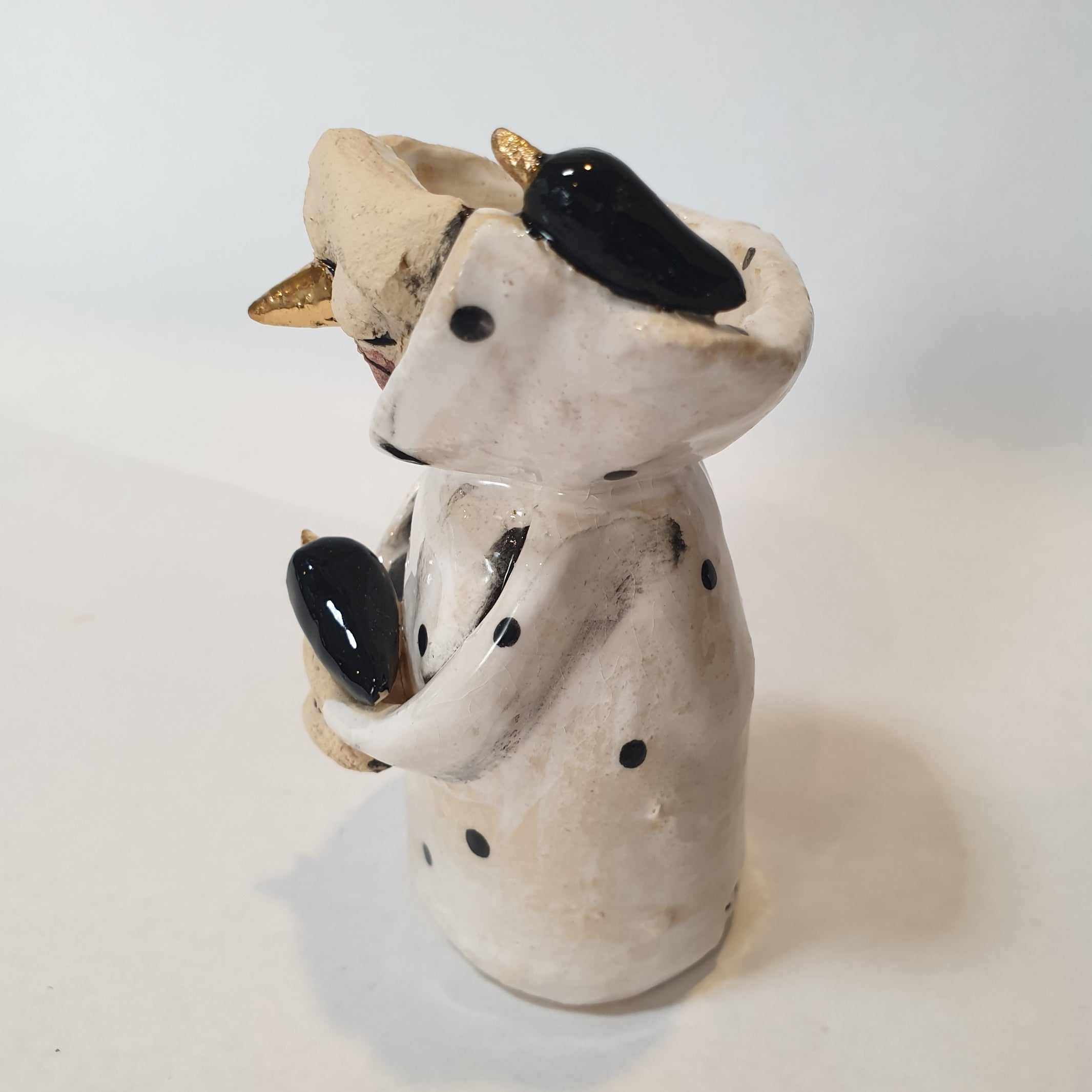 little clay character, birds and dots