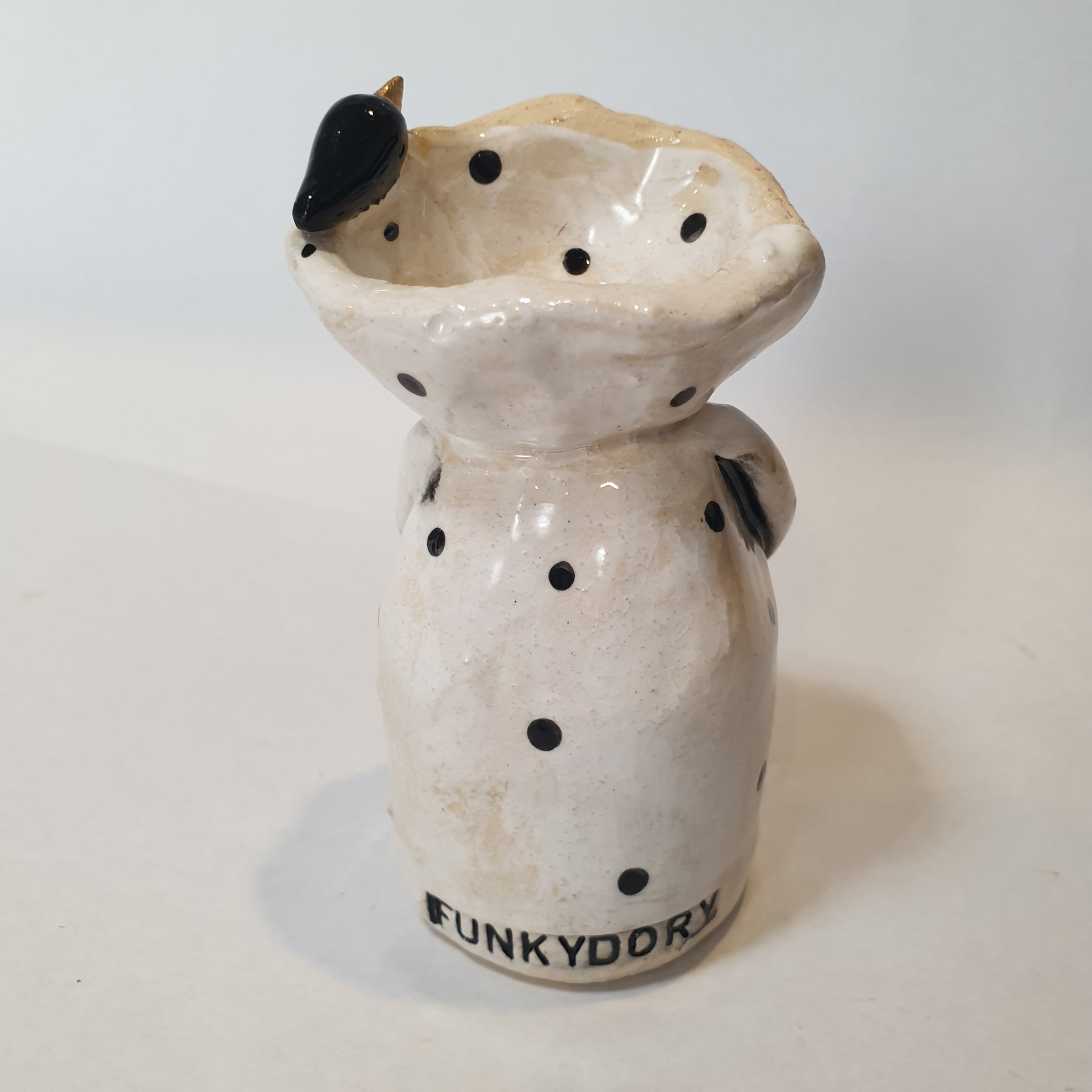 little clay character, birds and dots