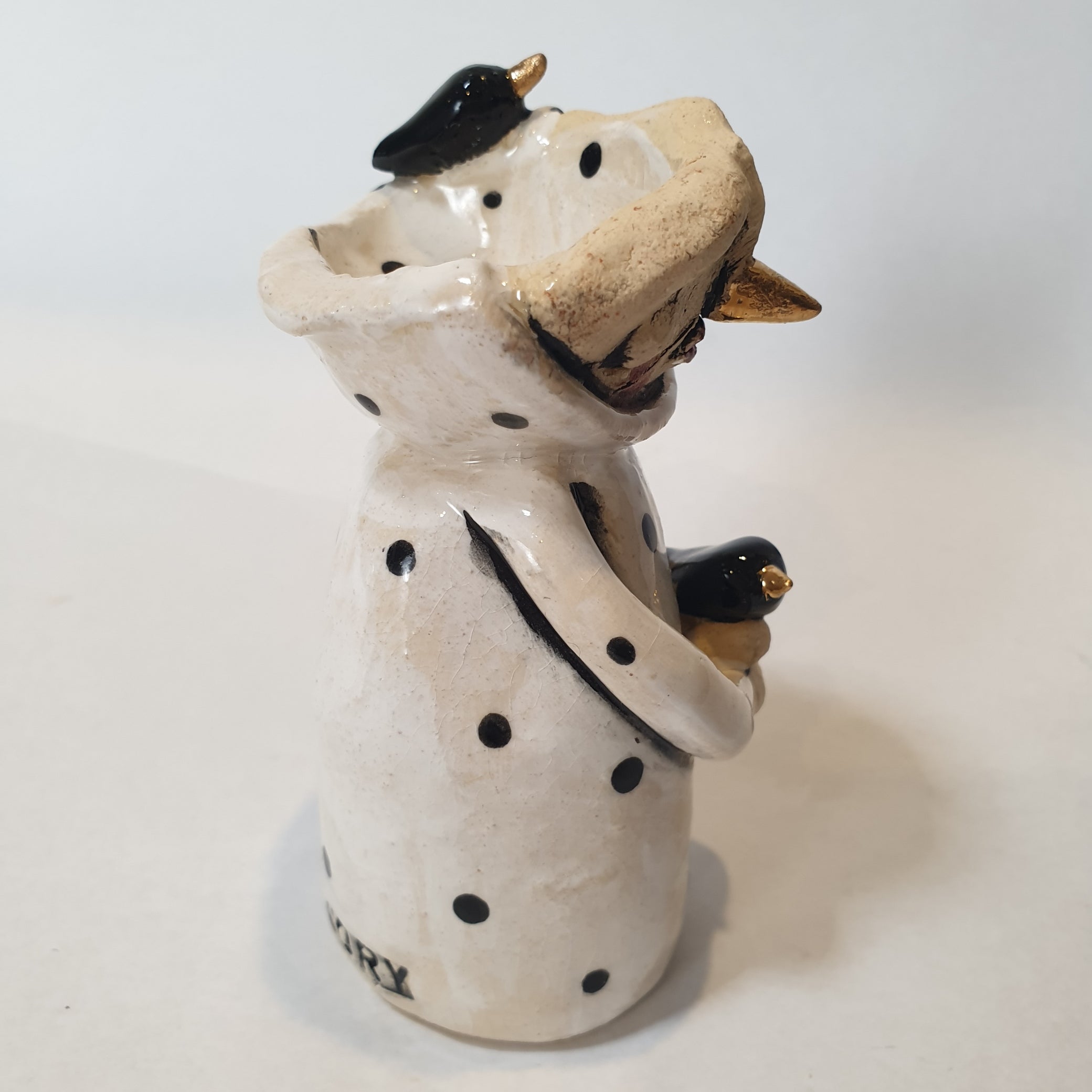 little clay character, birds and dots