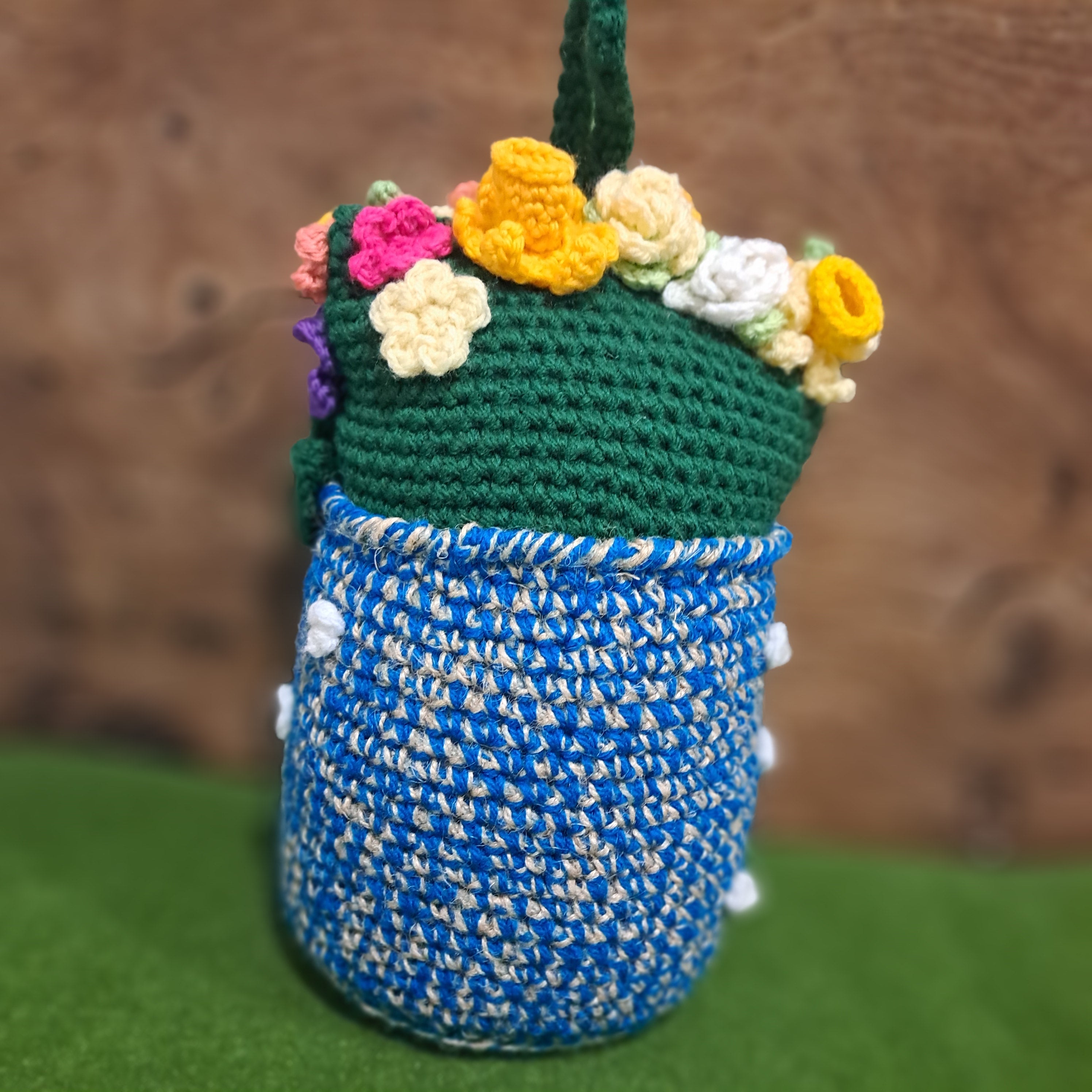 Crochet Doorstop vase of spring flowers.