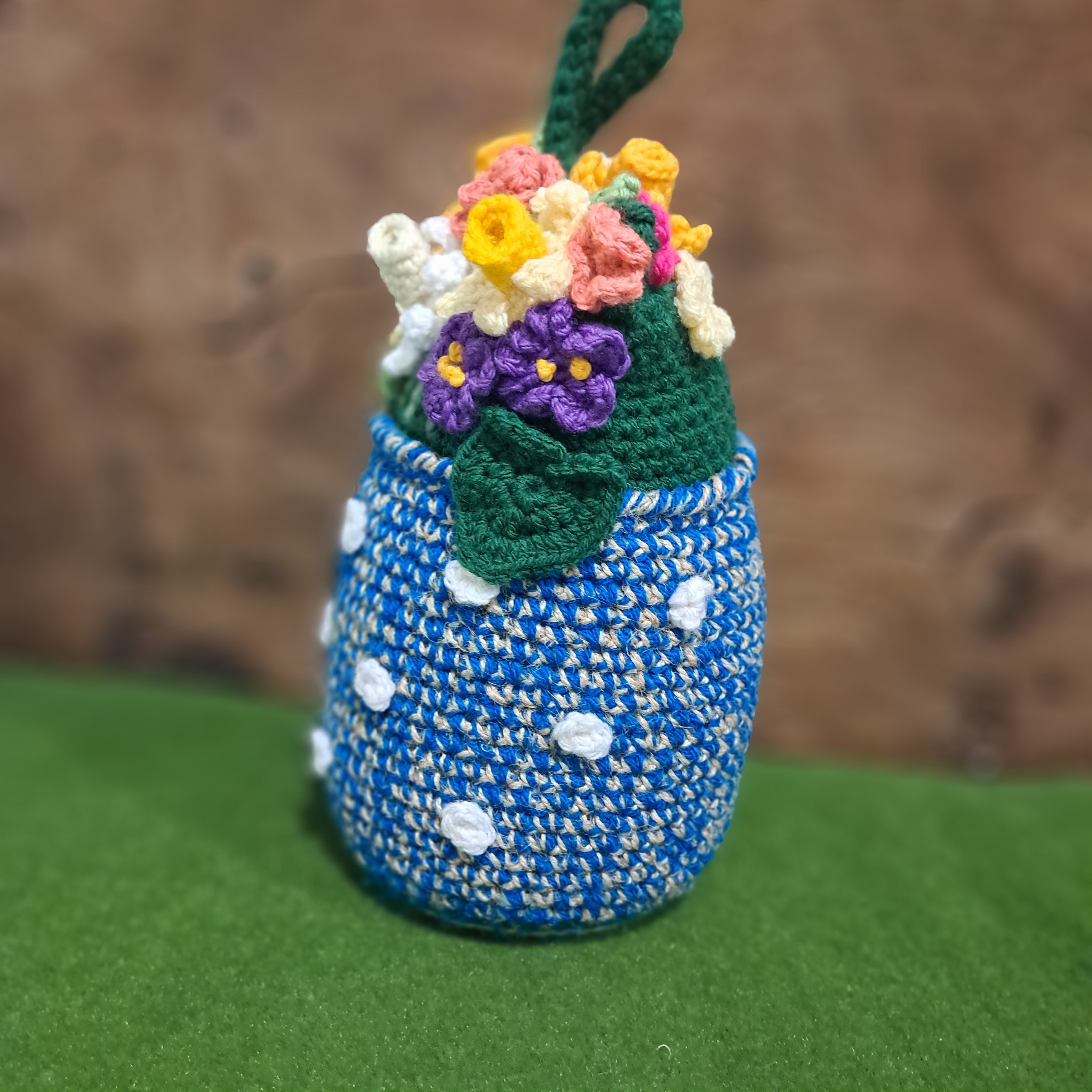 Crochet Doorstop vase of spring flowers.