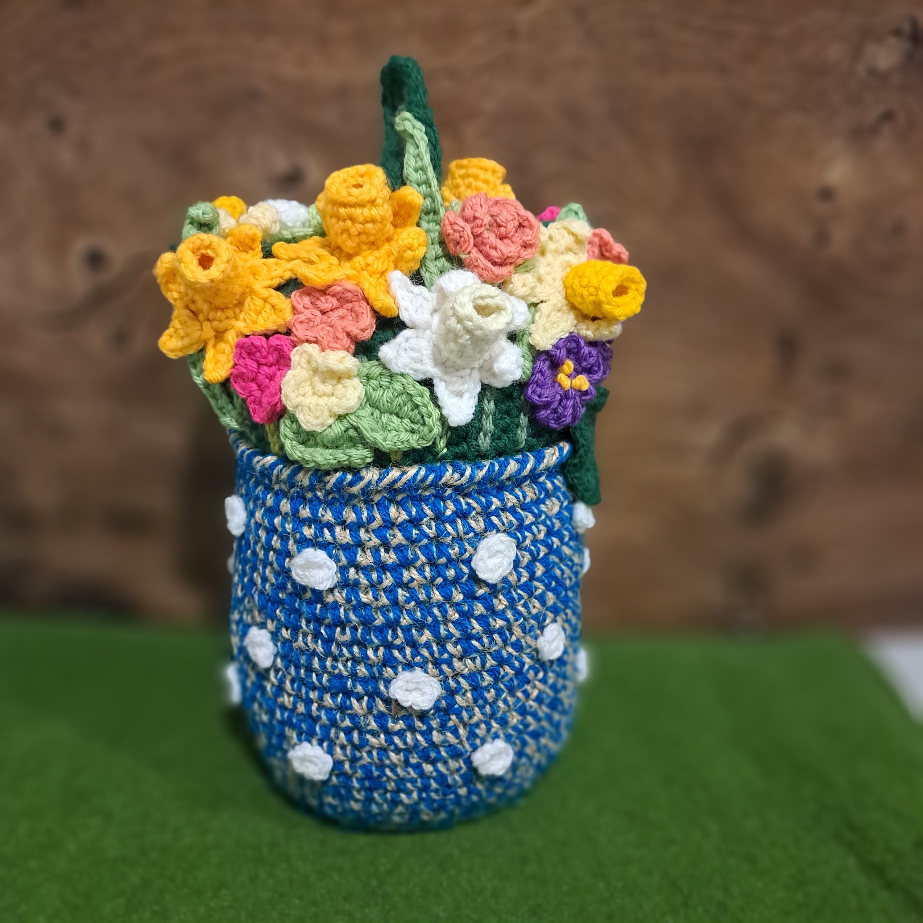 Crochet Doorstop vase of spring flowers.