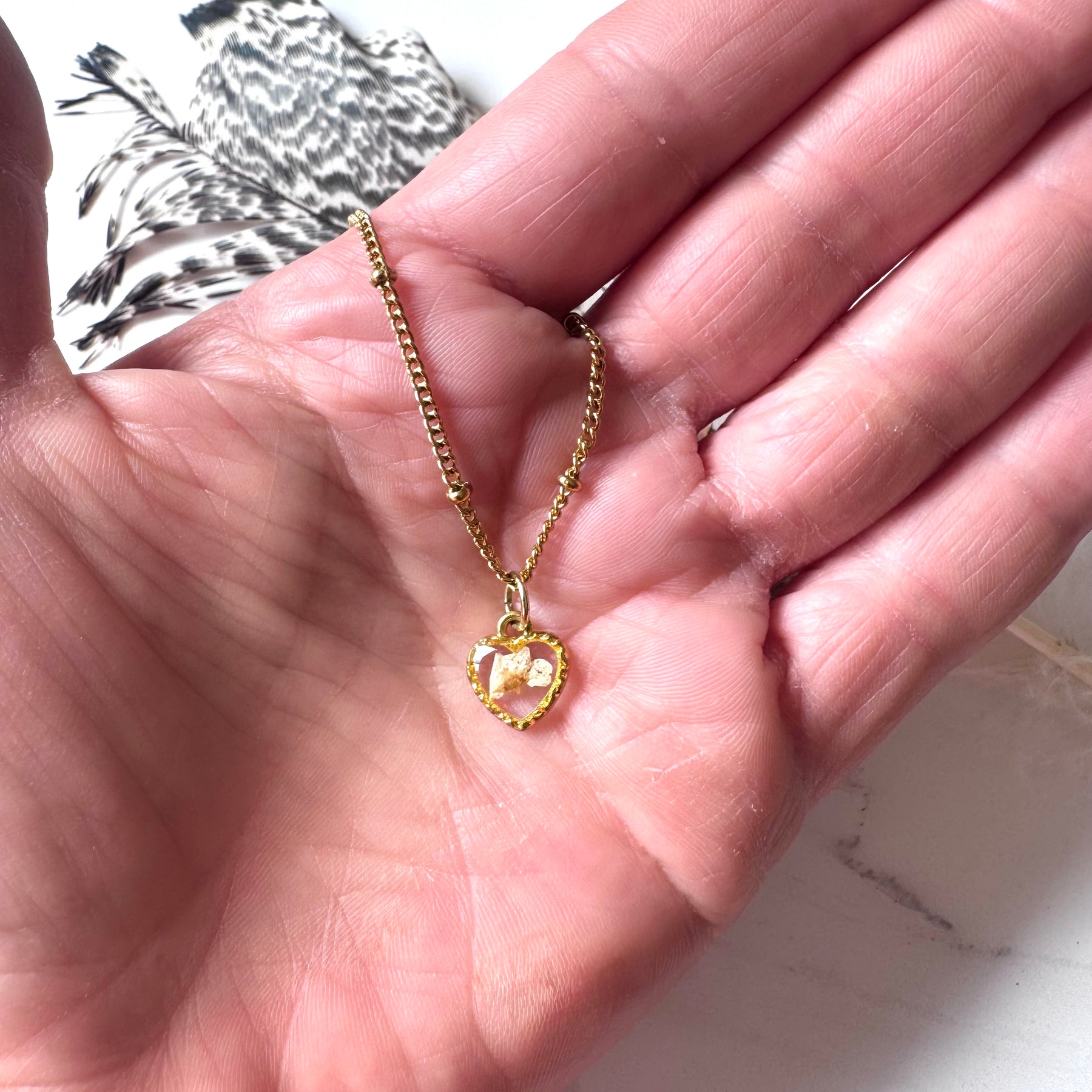 Gold plated resin necklace with white wildflower
