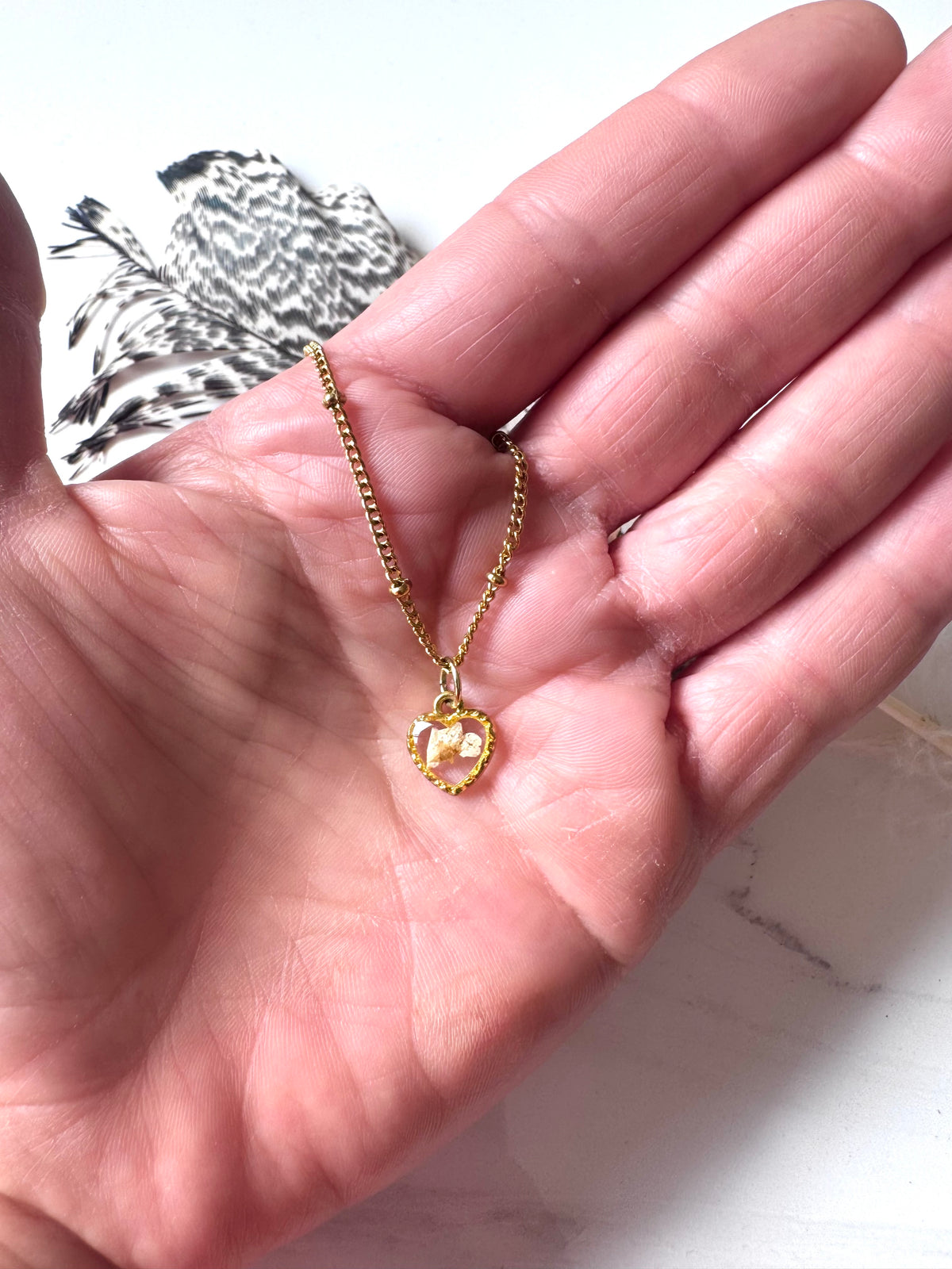 Gold plated resin necklace with white wildflower