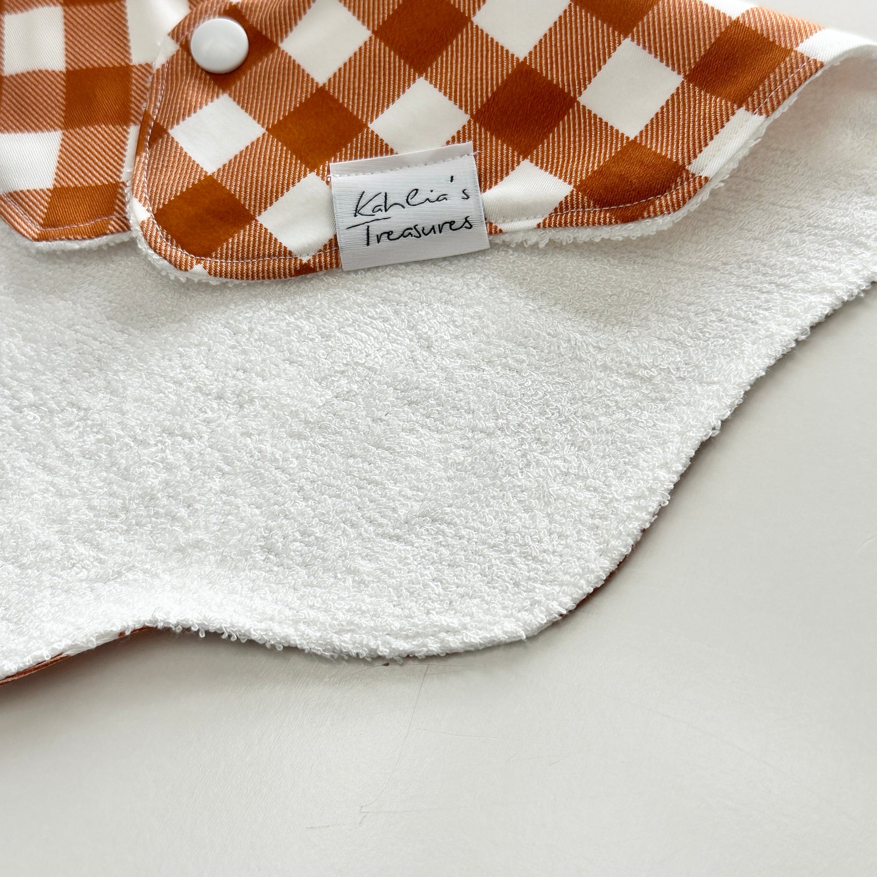 Rust gingham scalloped bib