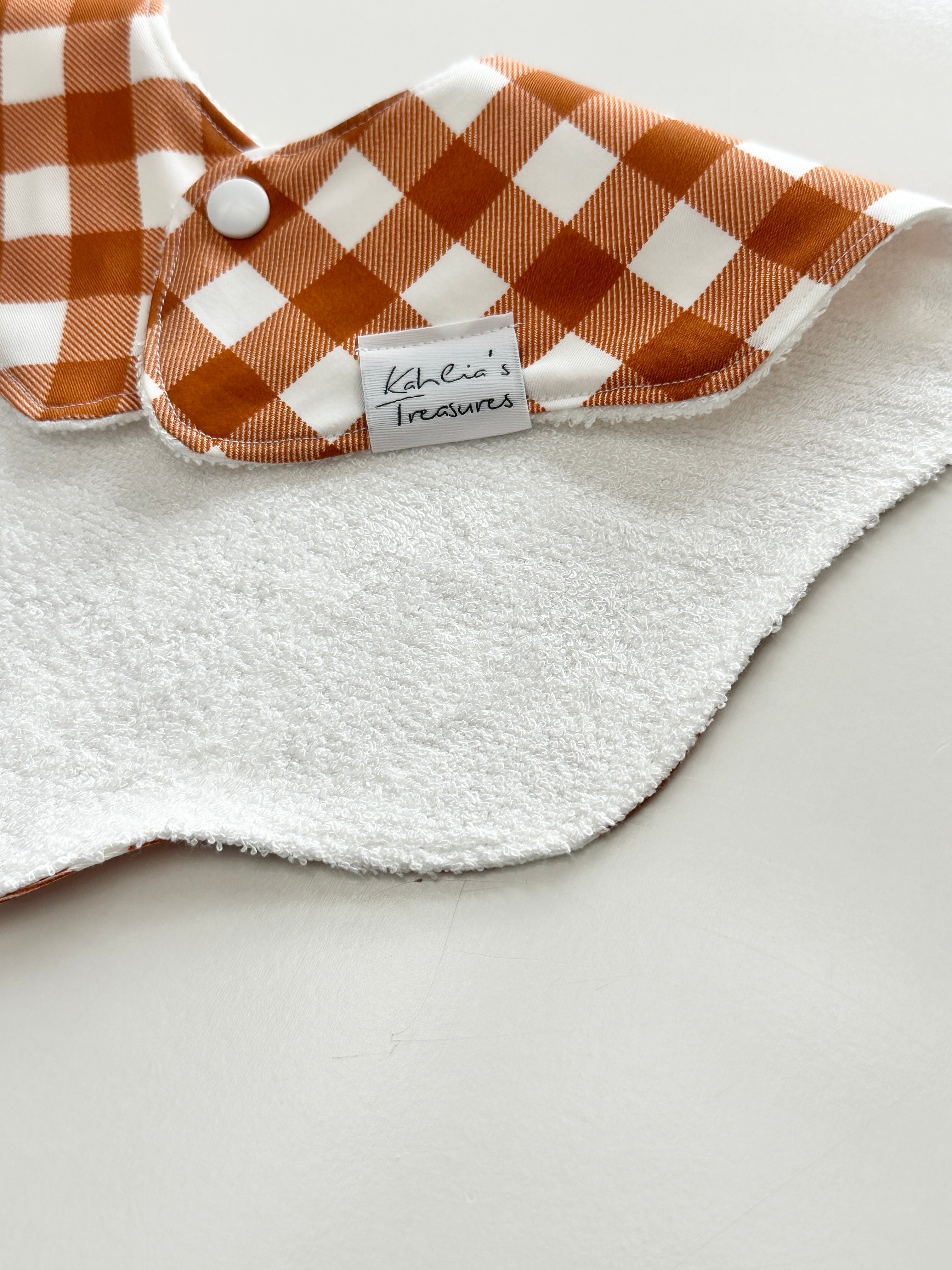 Rust gingham scalloped bib