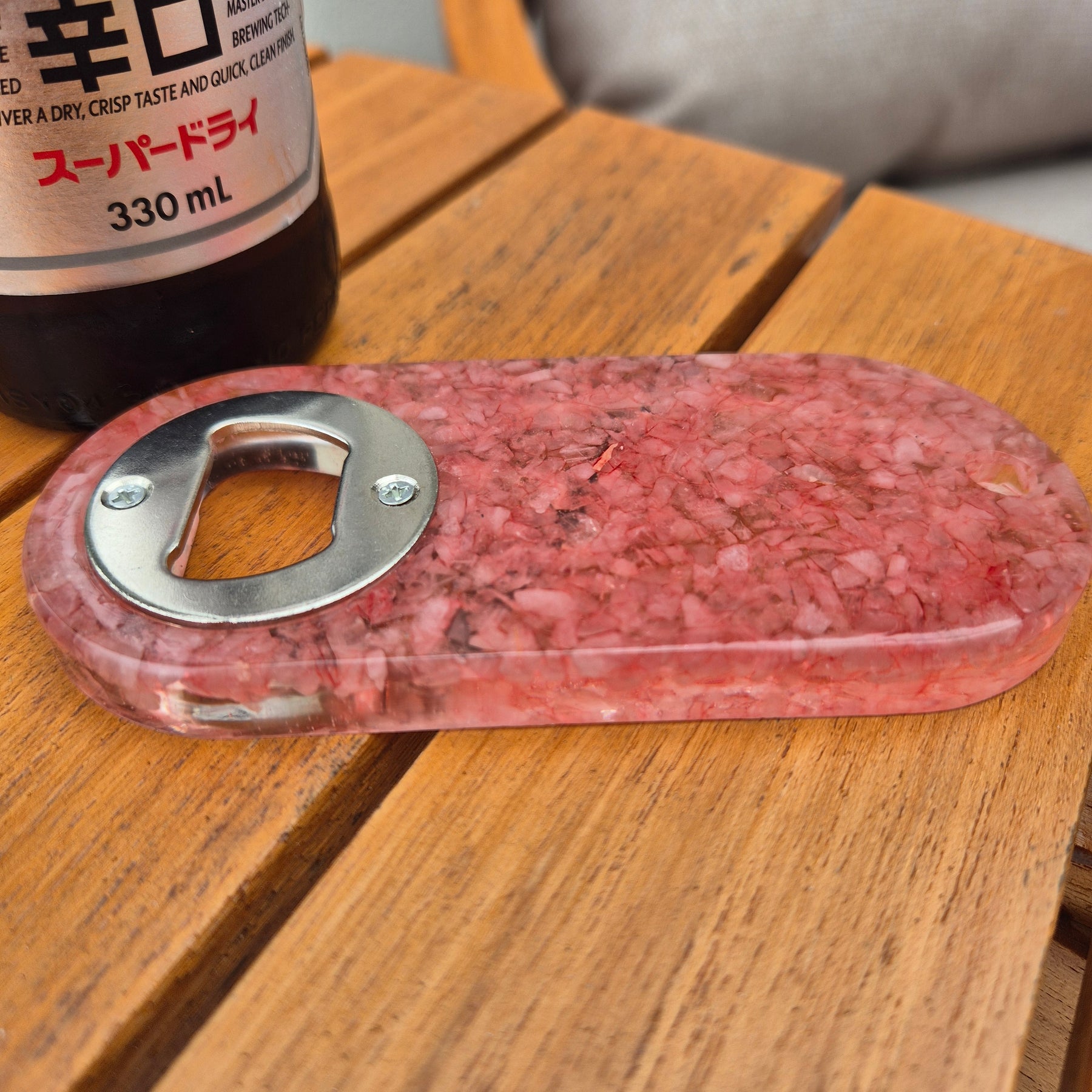 Resin bottle opener with inlaid rose quartz stones