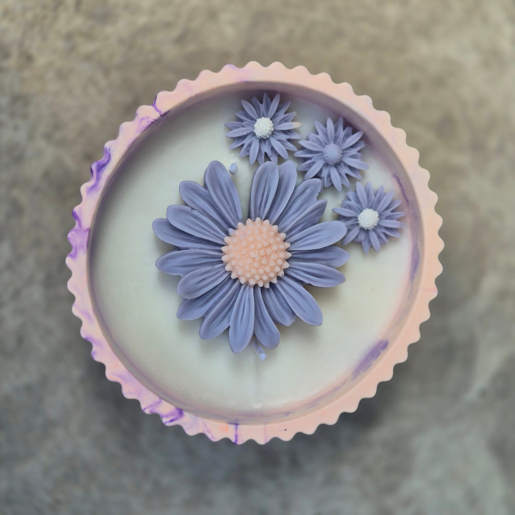 Round orange and purple concrete bowl candle with rose and lavender scent