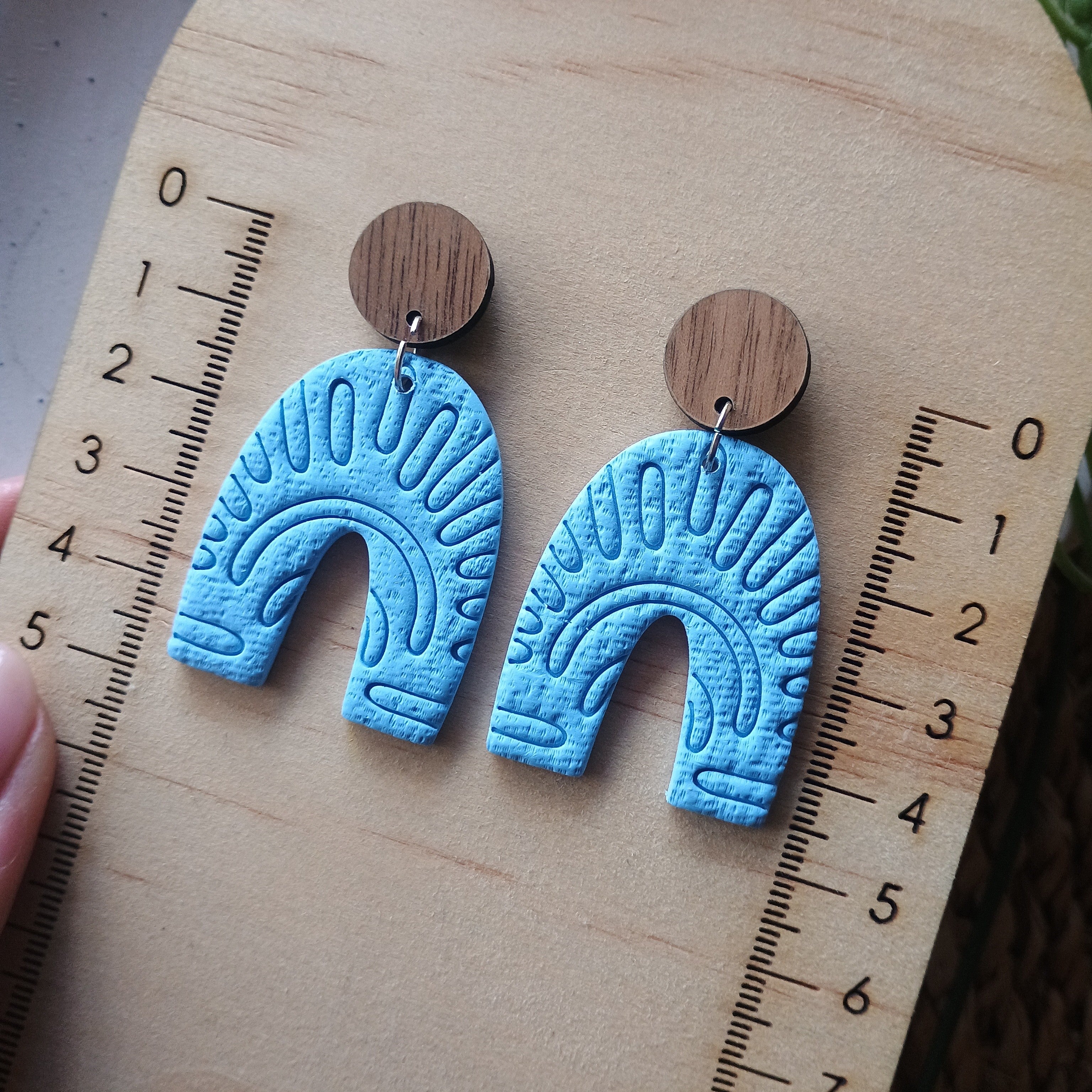 Embossed blue arch earrings with natural wood stud top
