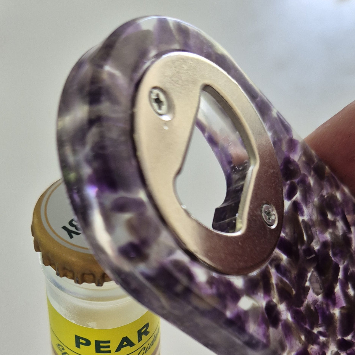 Resin bottle opener with inlaid amethyst stones