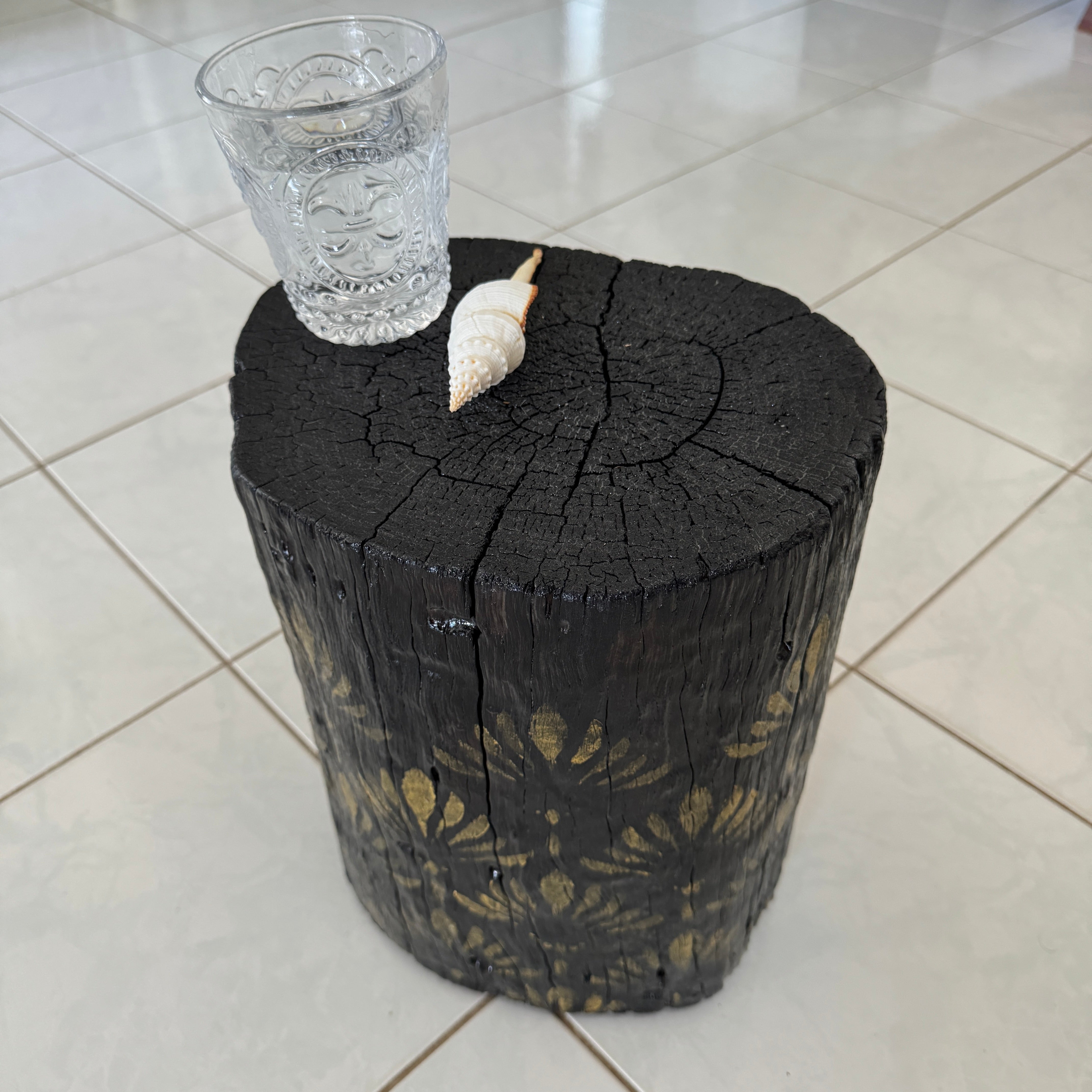 Burnt Timber stump table featuring gold hand-painted artwork