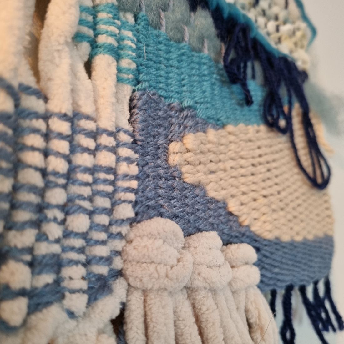 Handwoven wall hanging in blue and cream