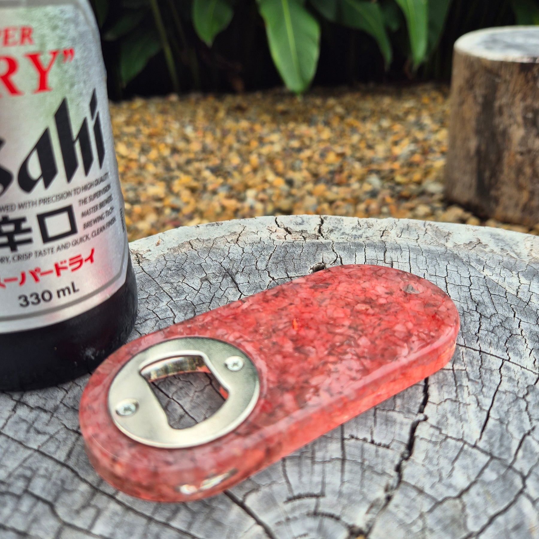Resin bottle opener with inlaid rose quartz stones