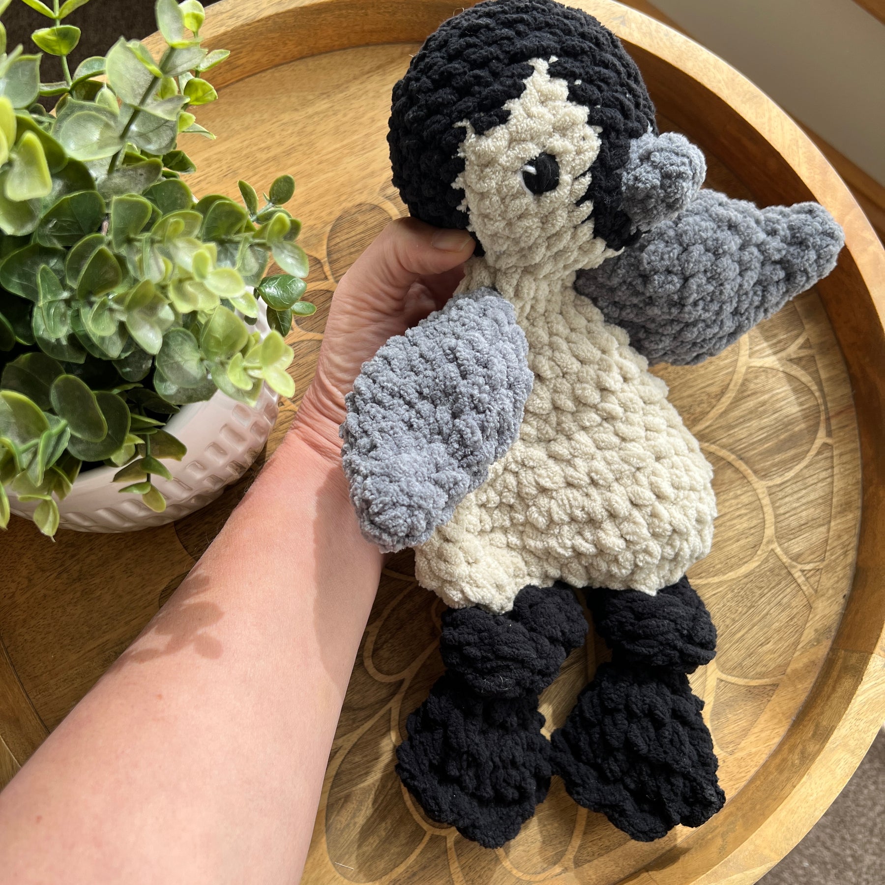 Handmade crochet modern Penguin lovey snuggler with knotted legs.