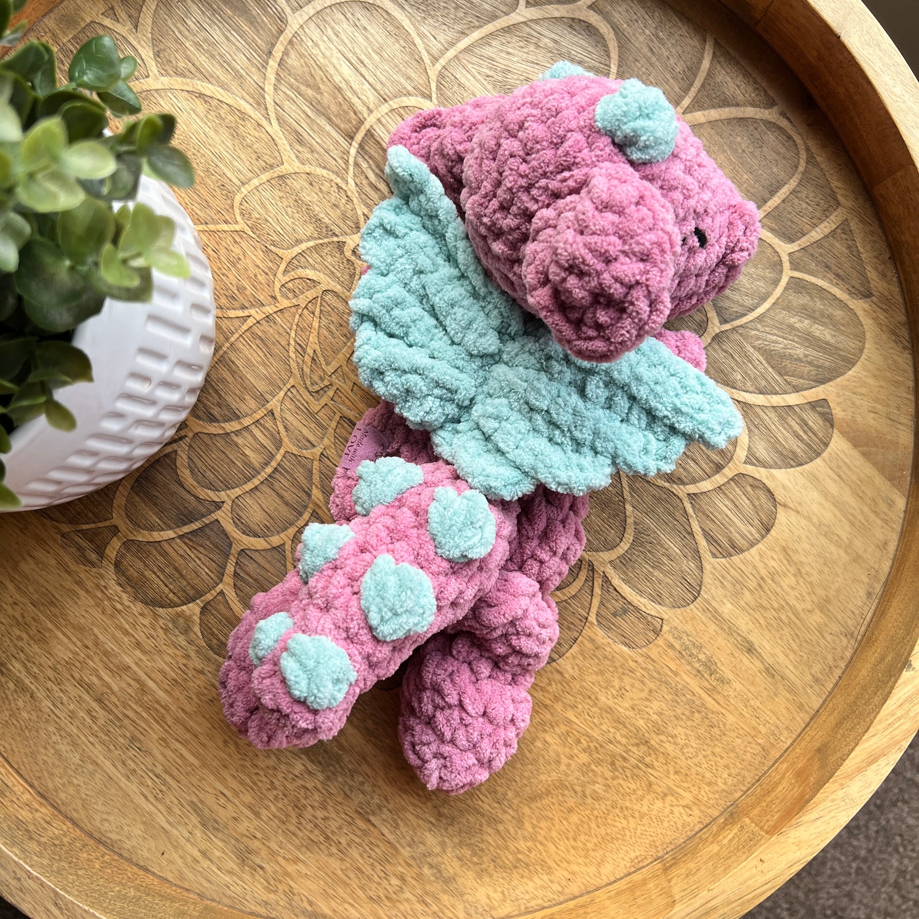 Handmade crochet Mini Dragon modern lovey with knotted legs and rainbow spikes.
