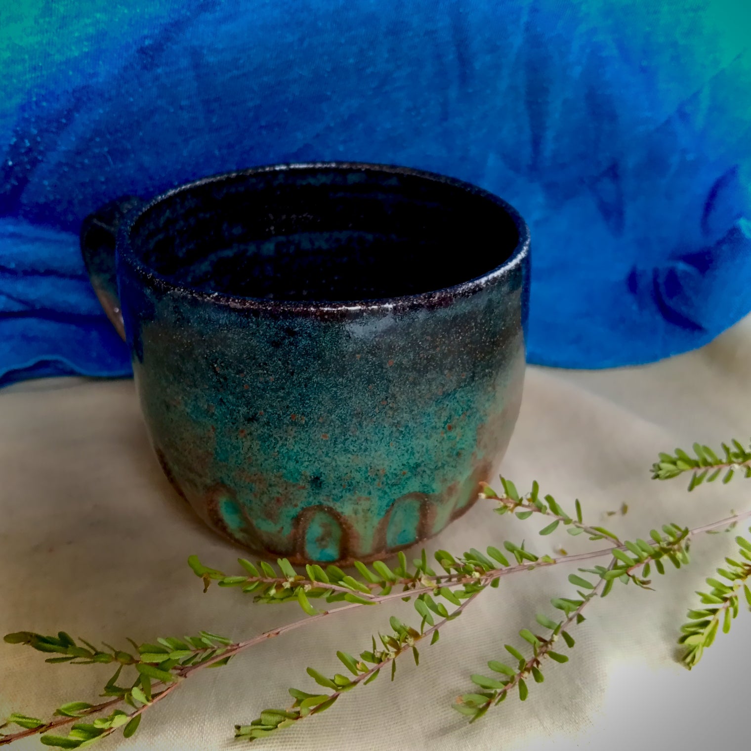 Blue & teal mug on rustic dark clay